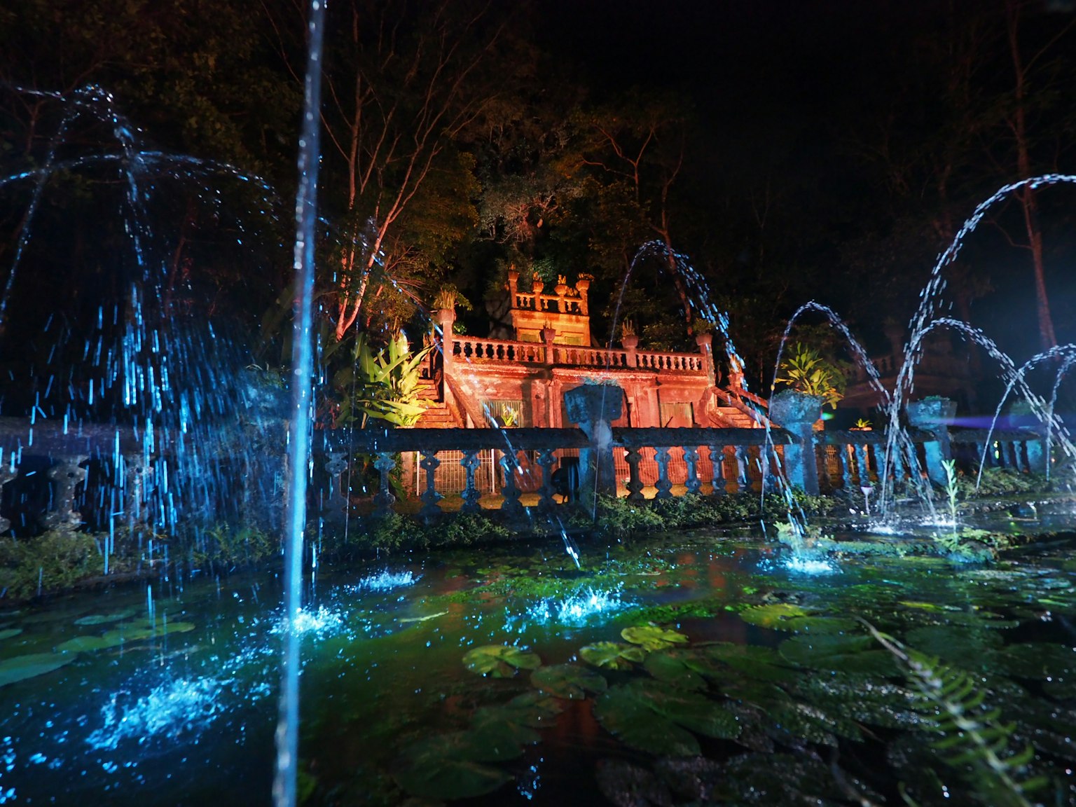 Beleuchteter Brunnen und bezauberndes Gebäude bei Nacht