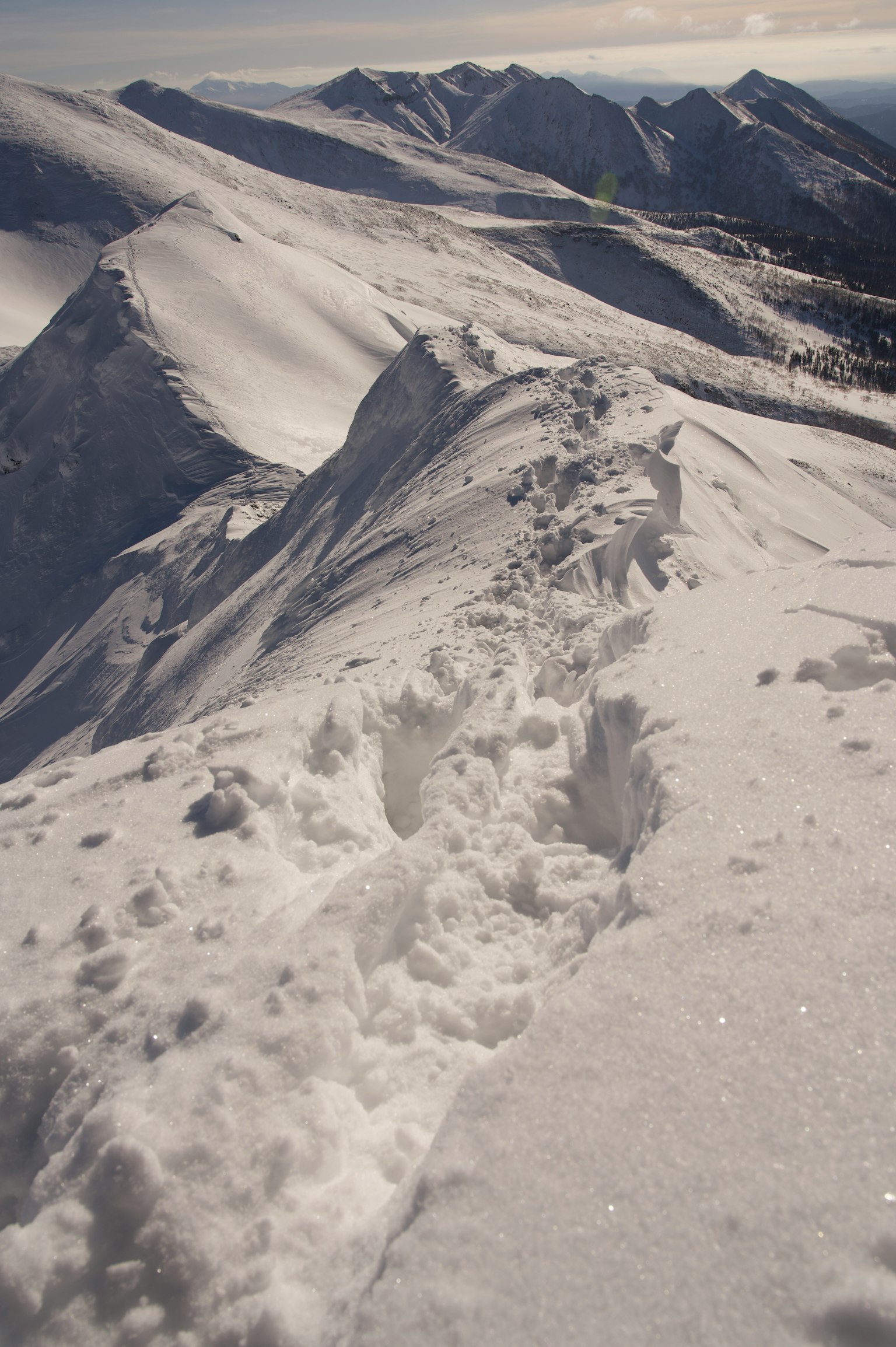 Scenic view of snow-covered mountain peak with footprints in the snow