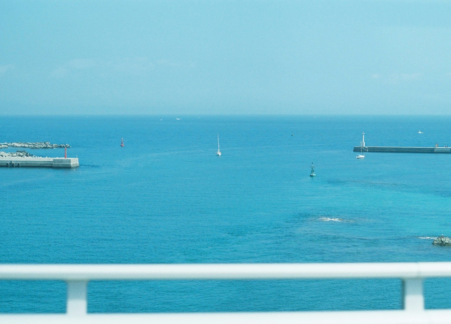 ทิวทัศน์ทะเลที่สวยงามพร้อมน้ำสีฟ้าและเรือใบ