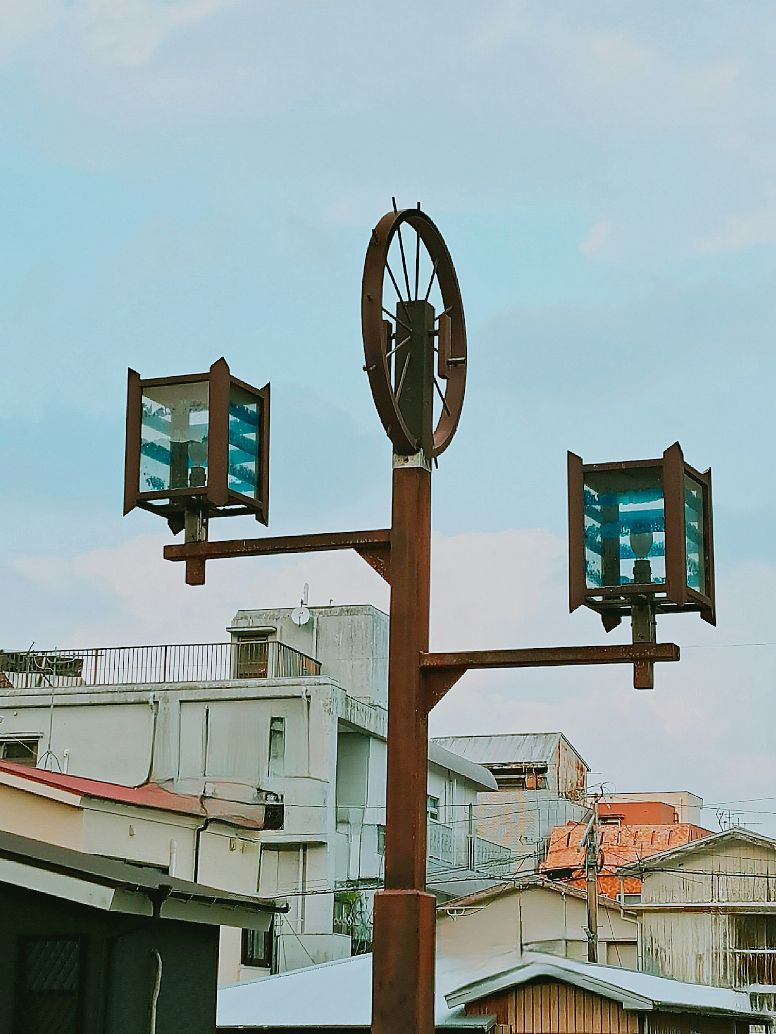 Unique streetlight with blue glass lamps in an urban setting