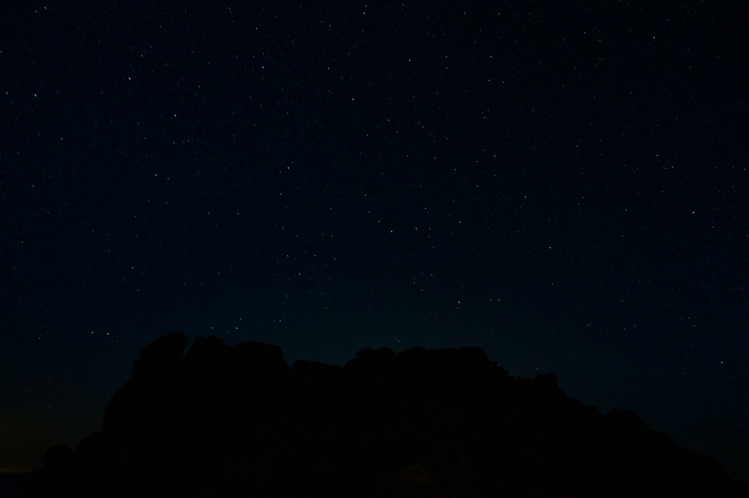 Cielo estrellado con silueta de montañas