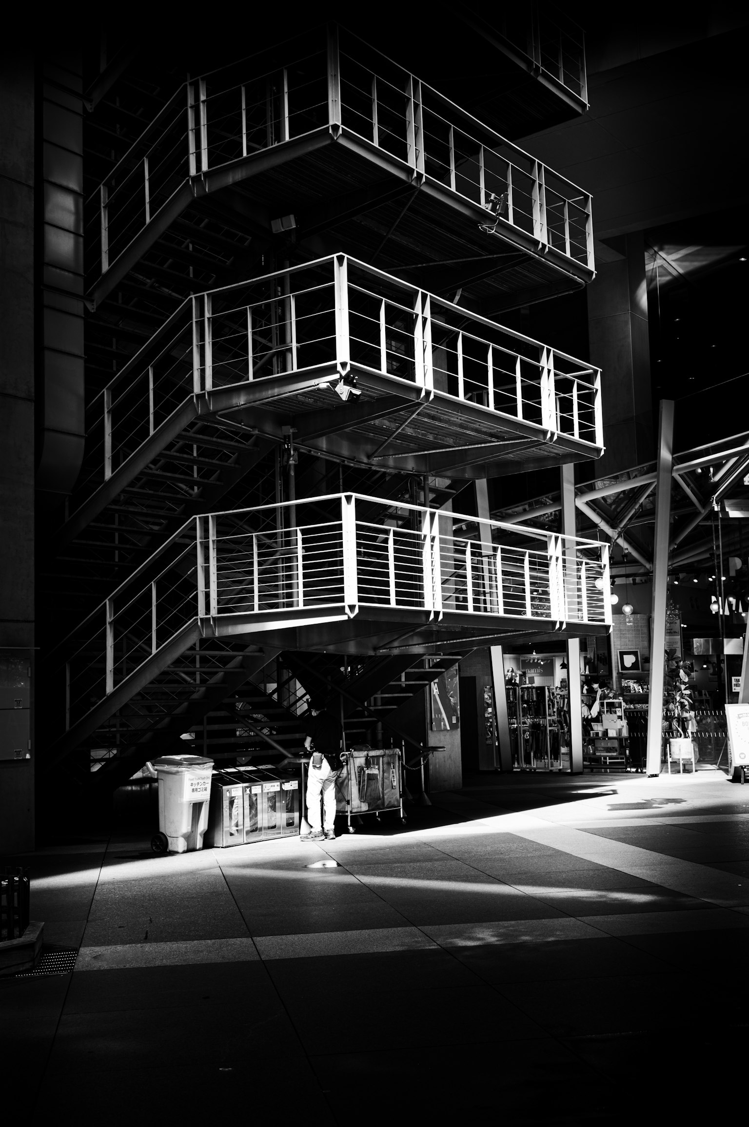 Black and white urban staircase structure with a human silhouette