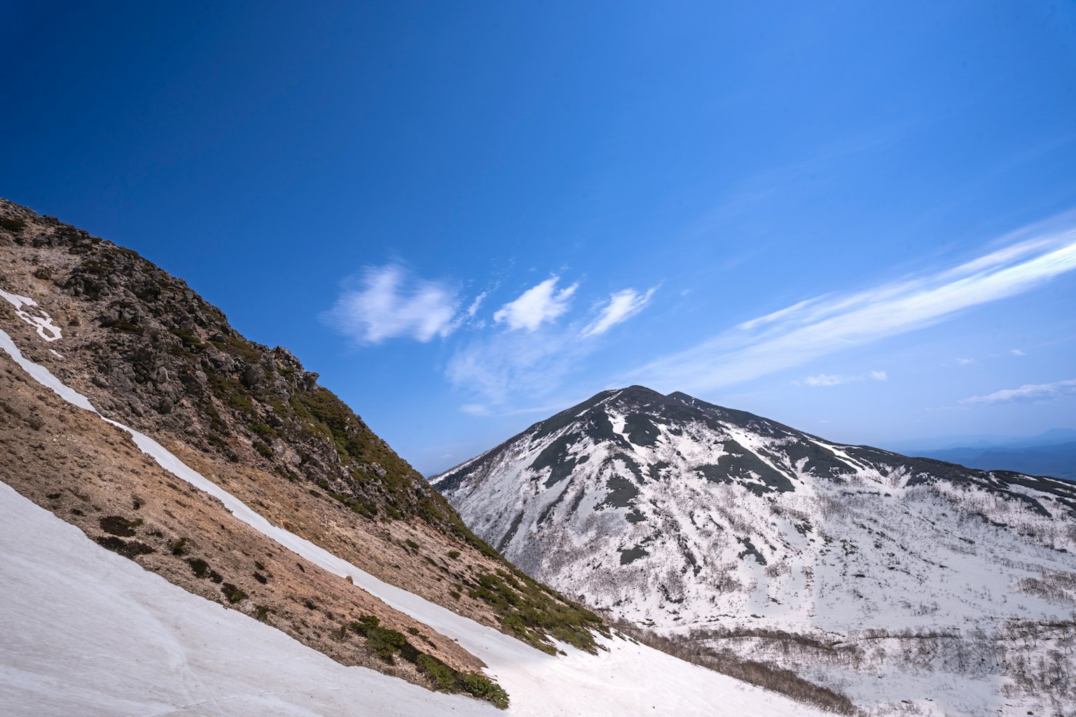 Snow-covered mountains under a clear blue sky