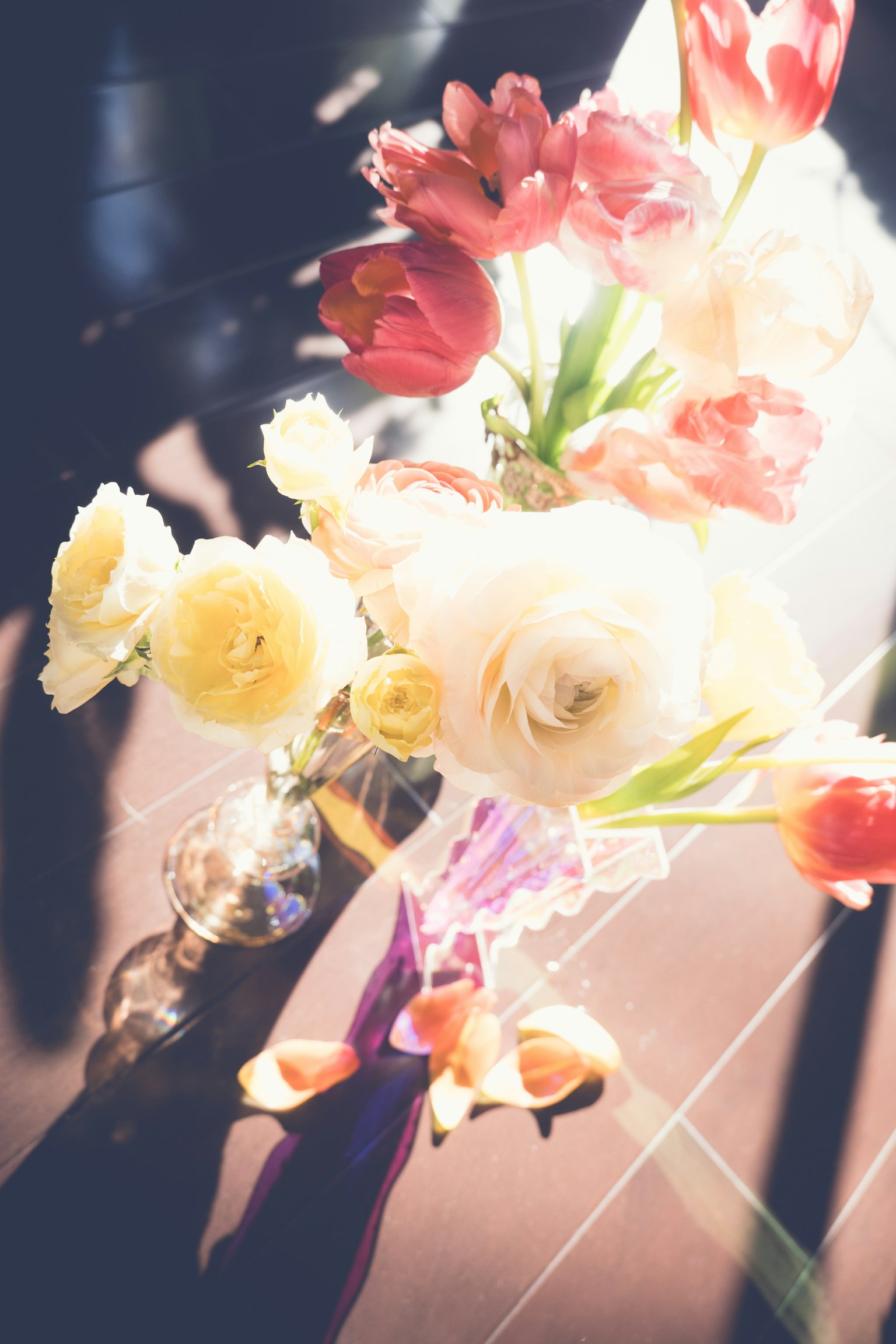A bouquet of colorful flowers in a vase illuminated by soft light