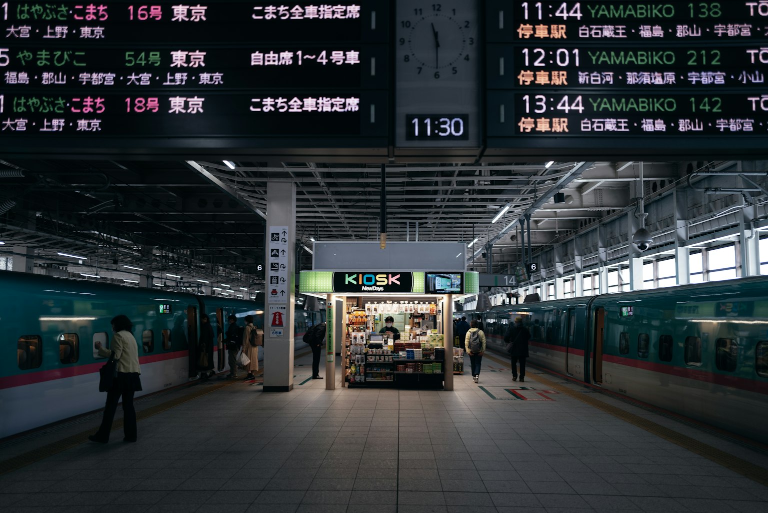 火車站月台上人們和數字時刻表的視圖