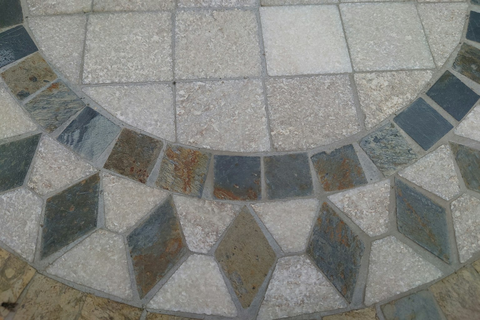 Circular floor design featuring intricate stone patterns