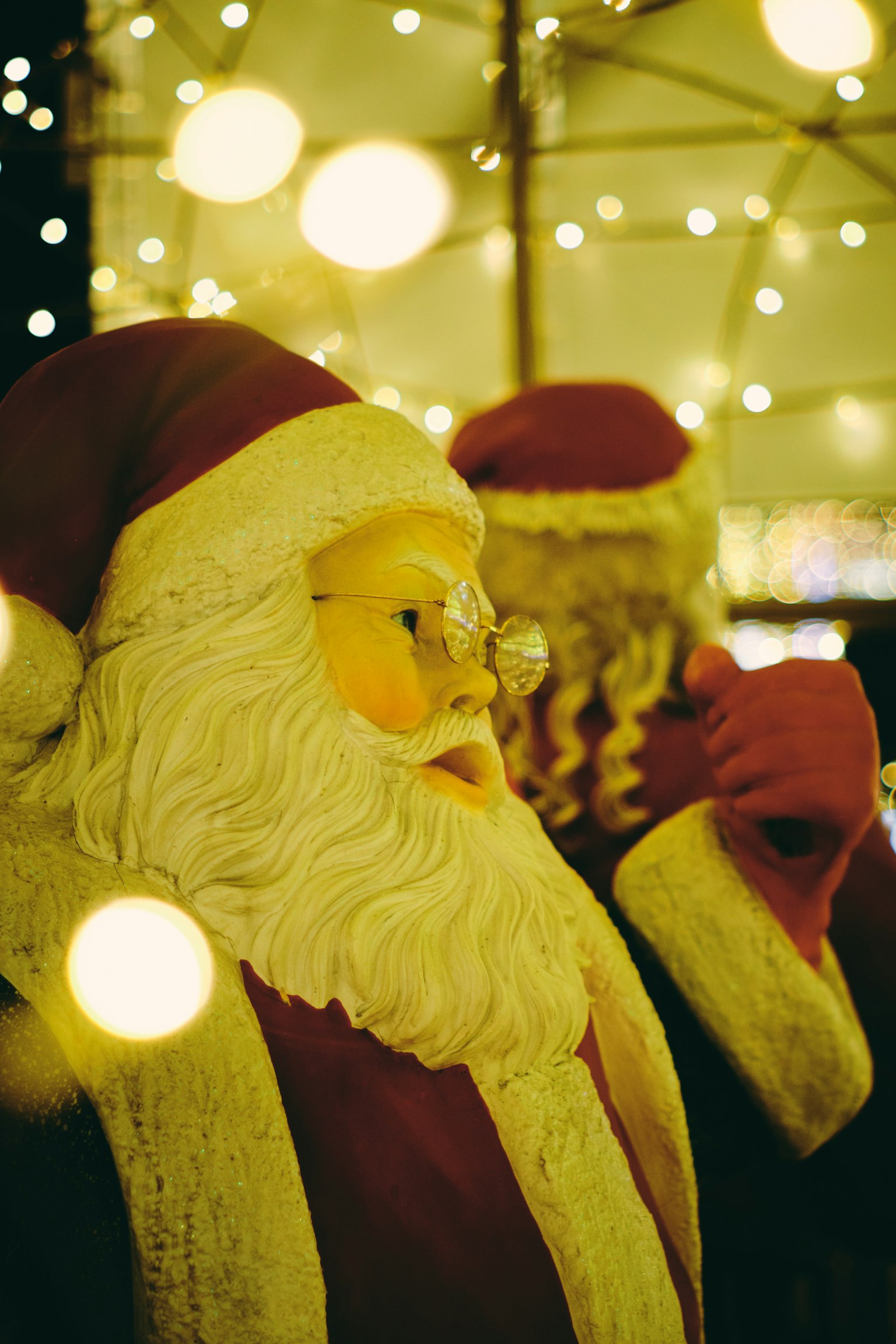 Christmas Santa Claus figures surrounded by soft glowing lights