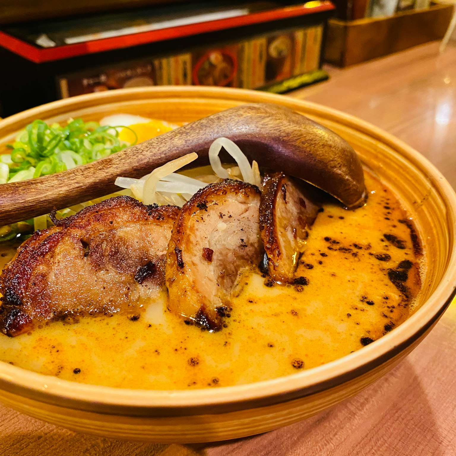 Bowl of delicious ramen topped with grilled pork and green onions