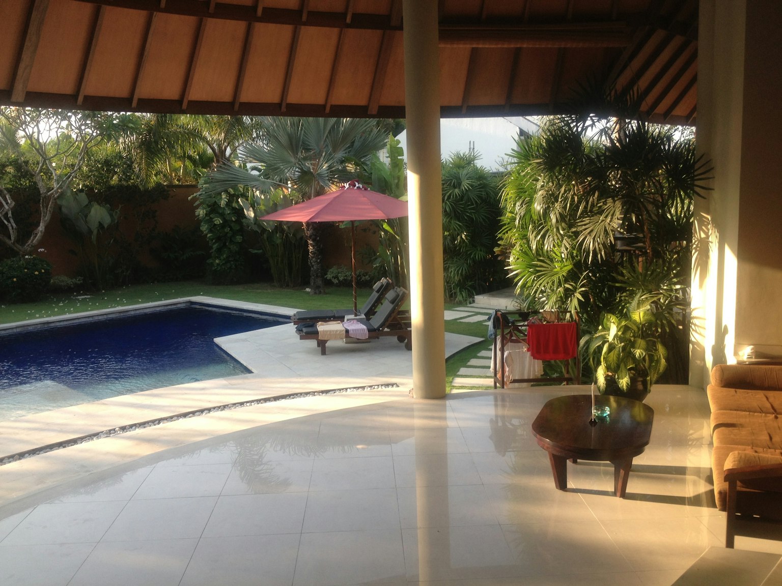 Resort-style garden with a swimming pool and umbrella