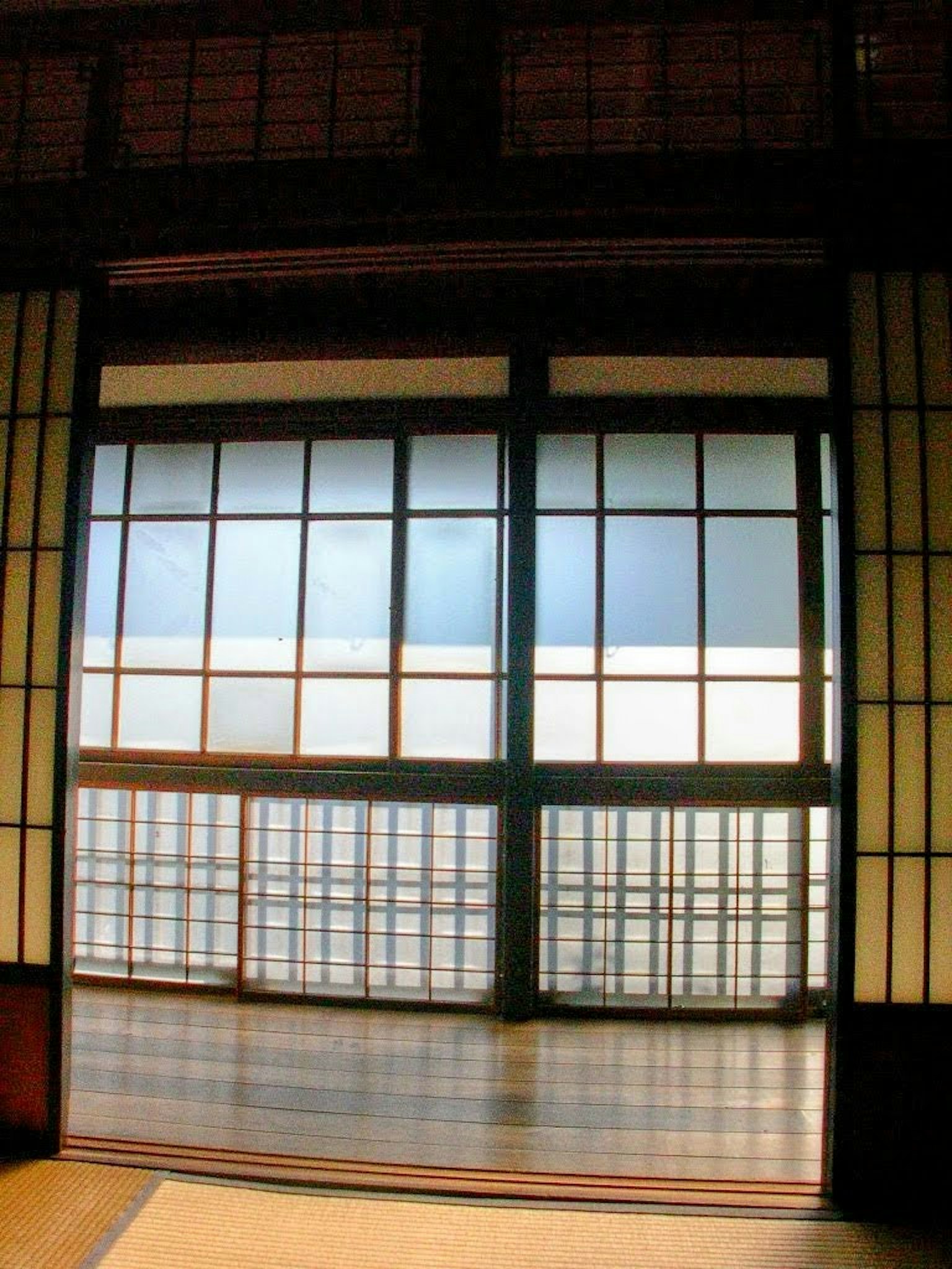View through traditional Japanese shoji doors showcasing natural light