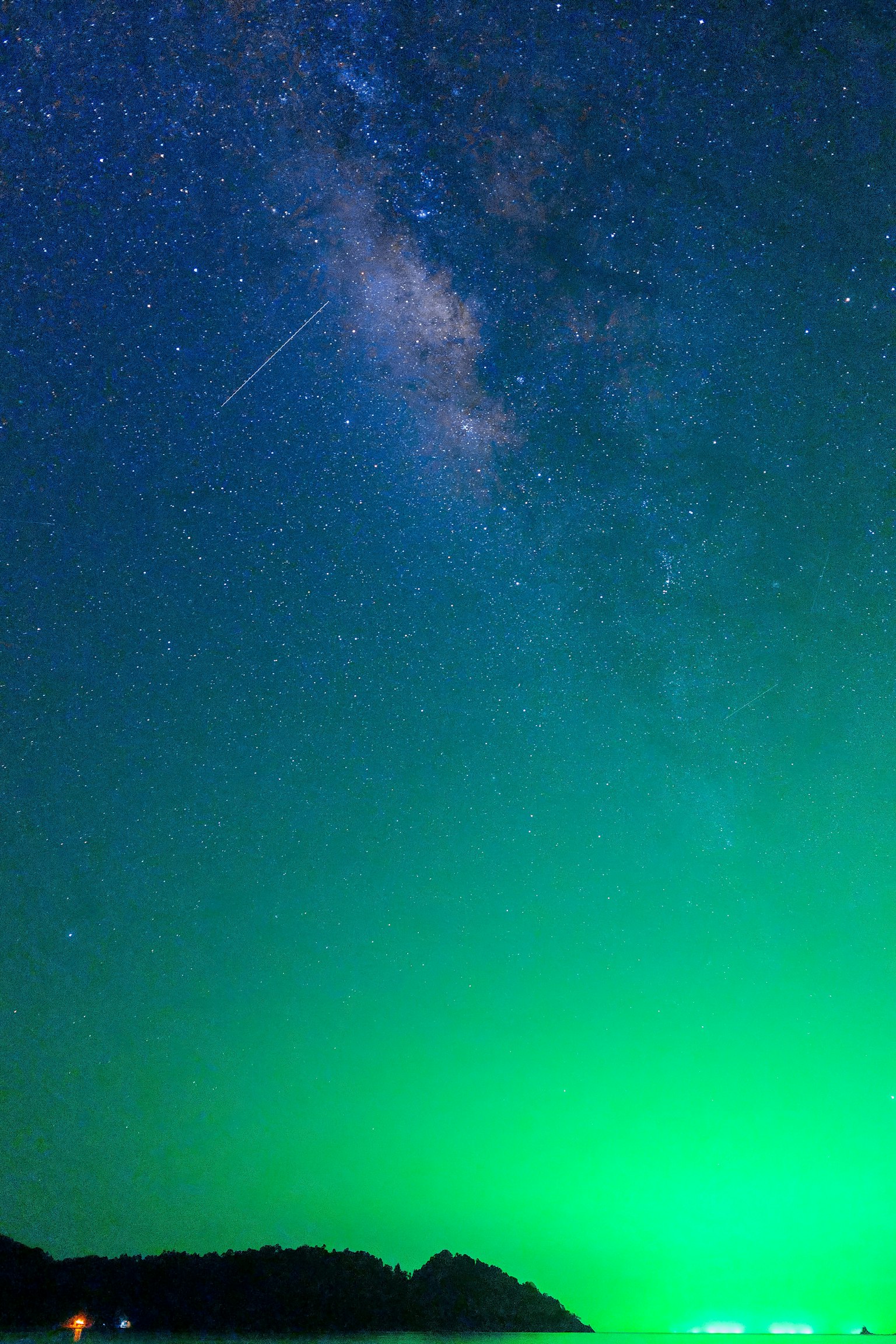 Starry sky with green aurora and the Milky Way