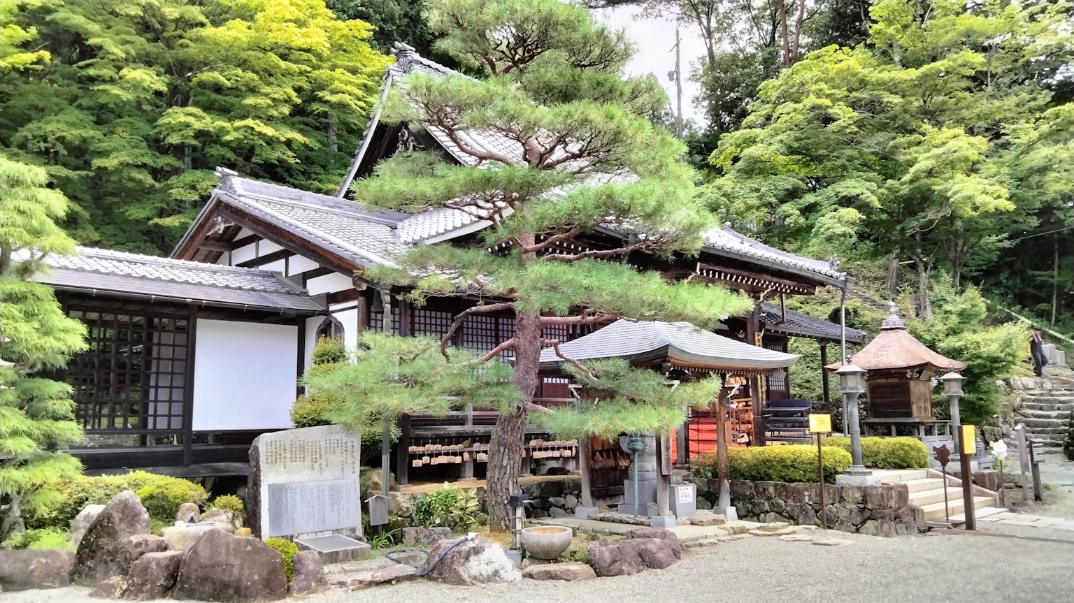 Traditional Japanese temple building surrounded by lush greenery