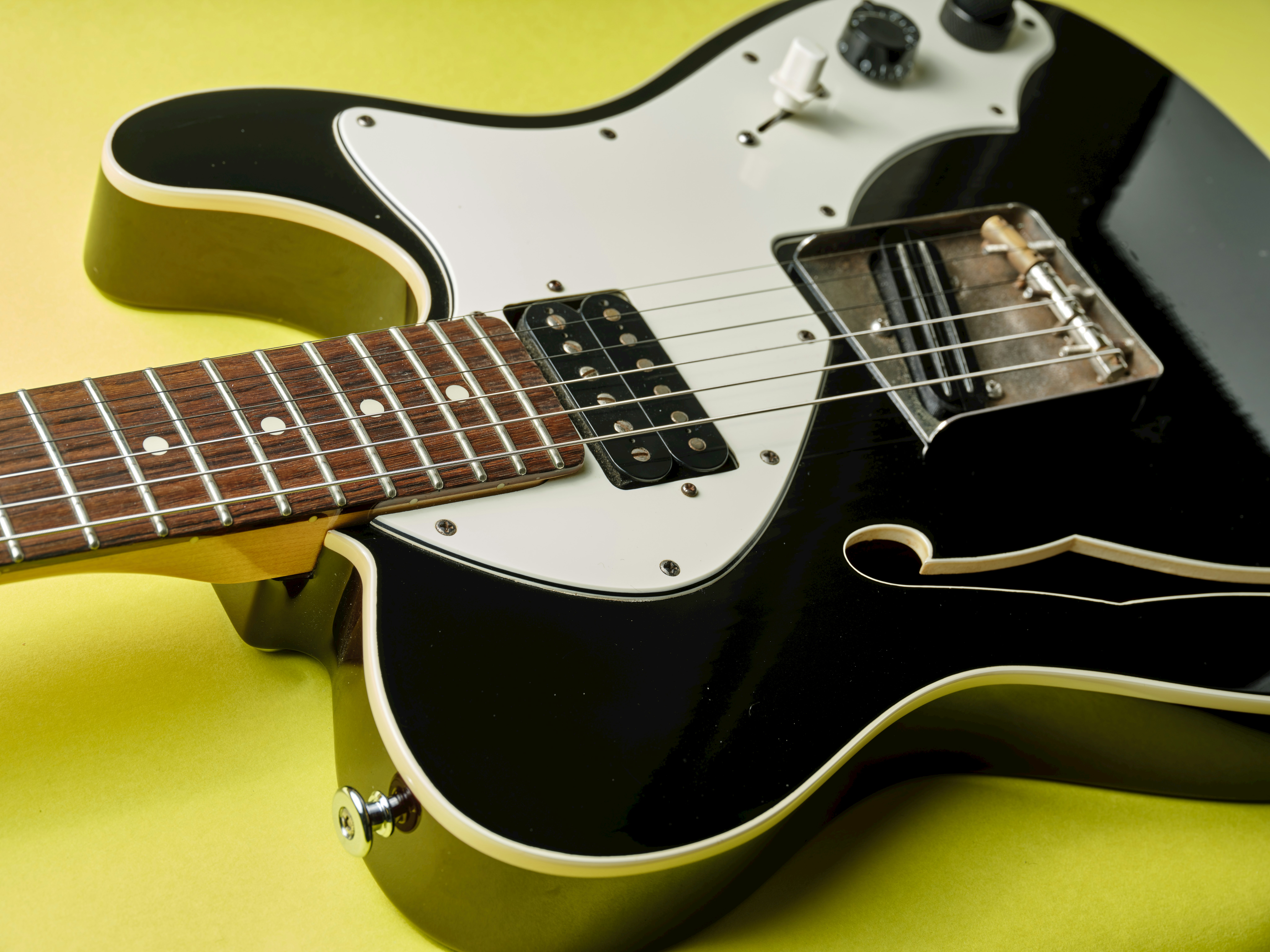 close-up of a black electric guitar