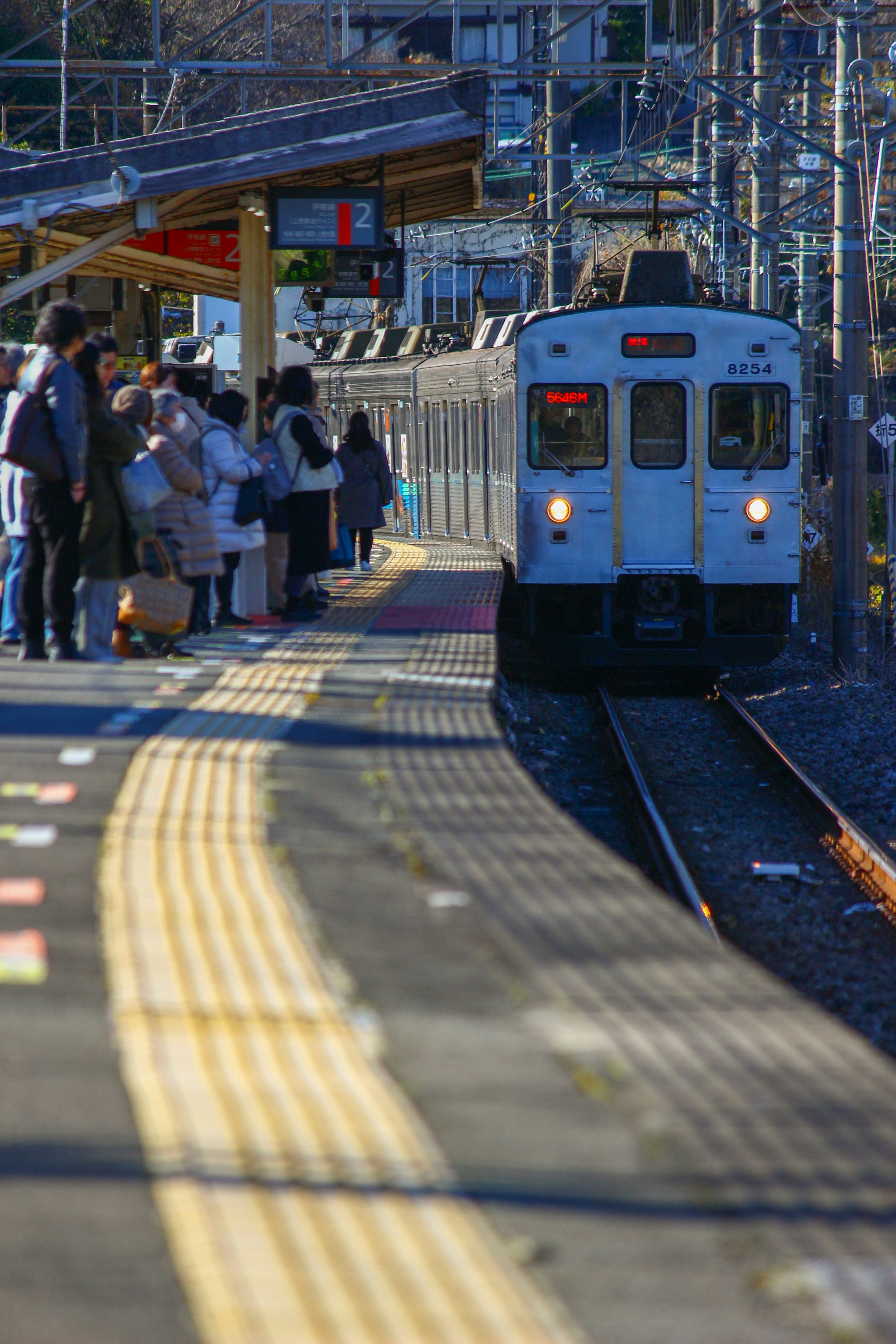 people waiting for a train on a station platform
