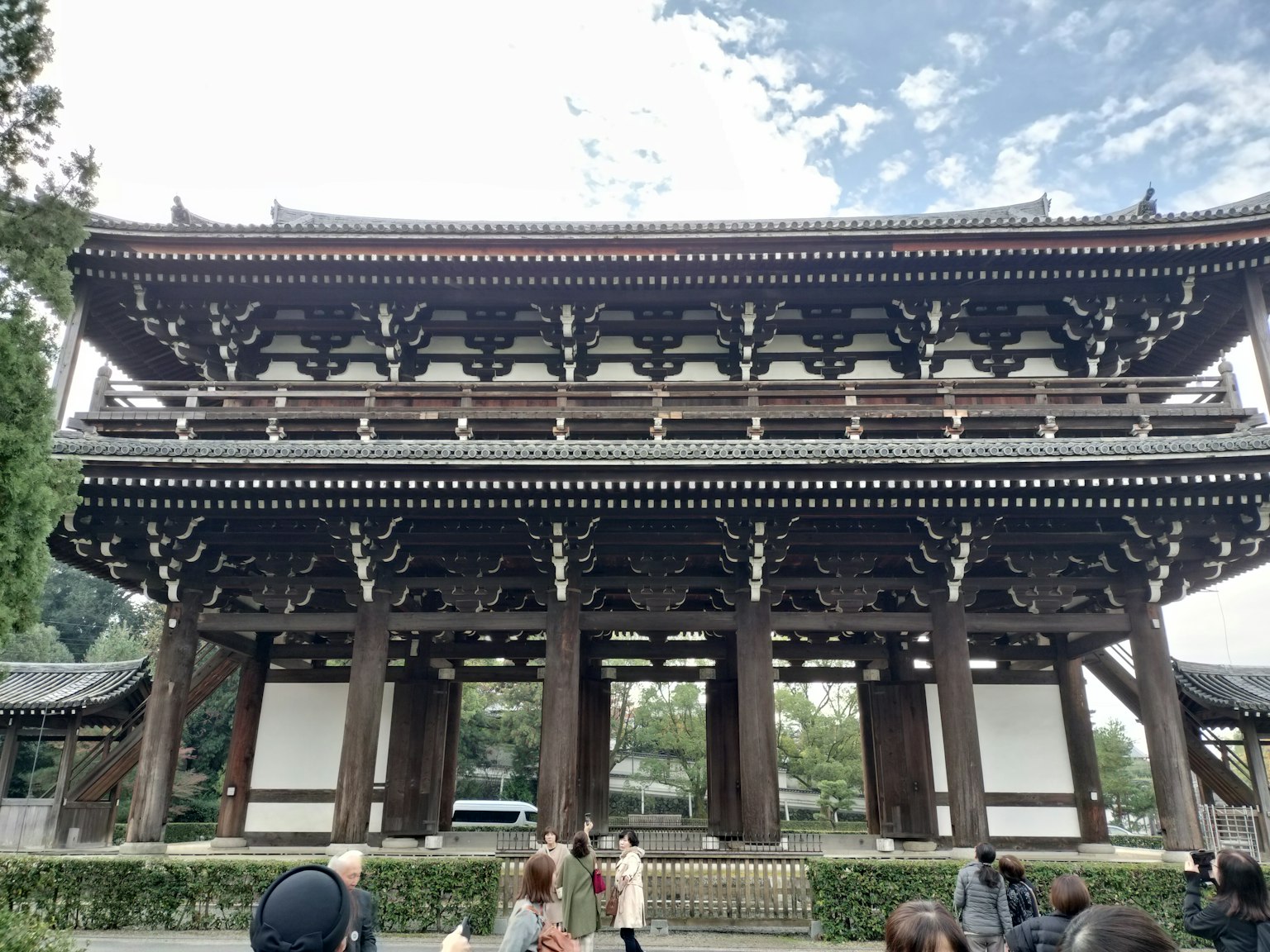 Menschen stehen vor einem traditionellen japanischen Architekturtor