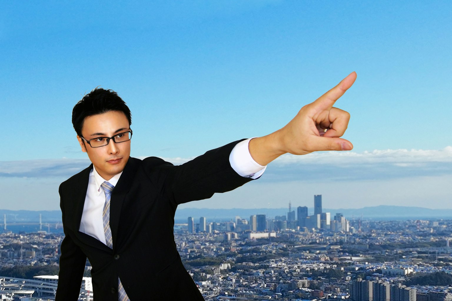 Businessman pointing with a city skyline in the background