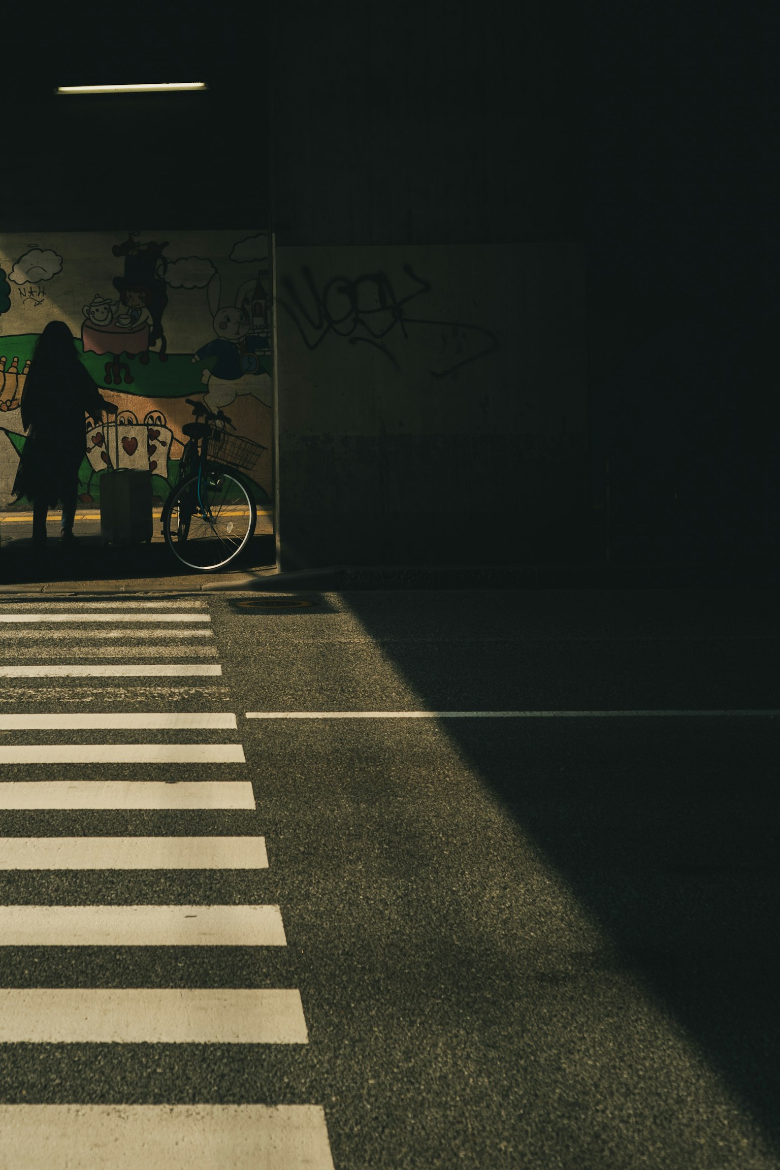 A scene featuring a crosswalk and a person against a dark background