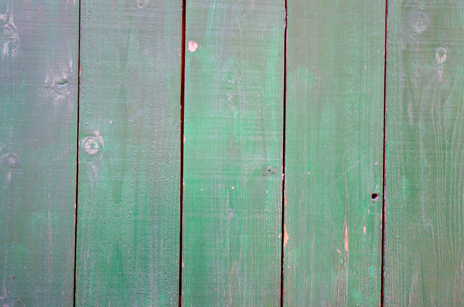 Vertical wooden planks in shades of green