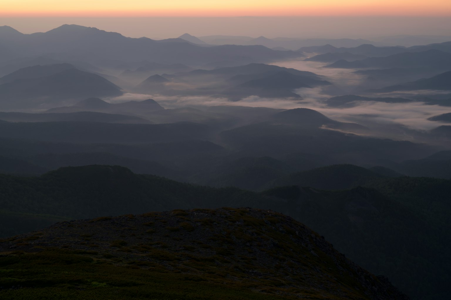 Morning landscape featuring mist-covered mountains and valleys