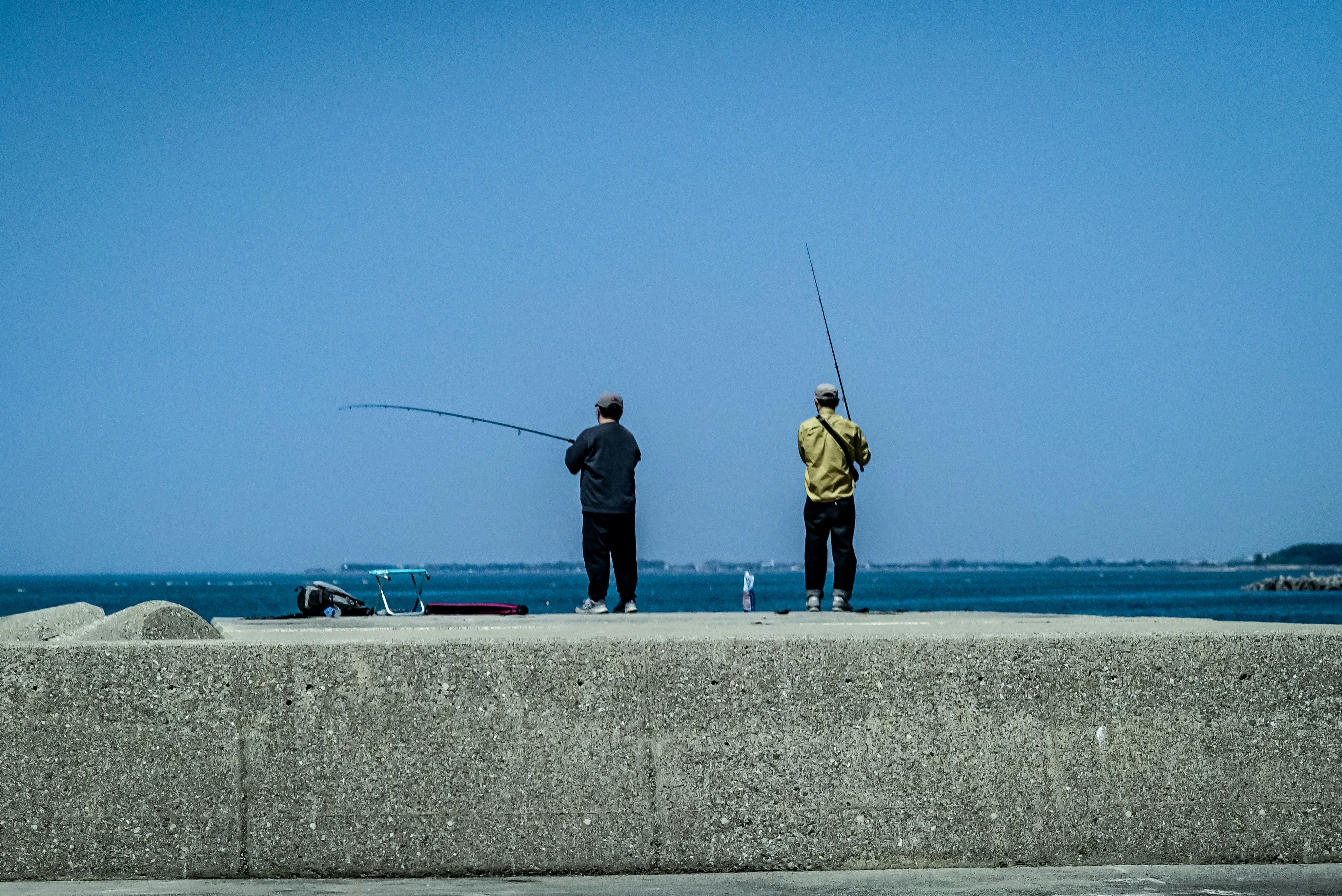 海边防波堤上的钓鱼伙伴