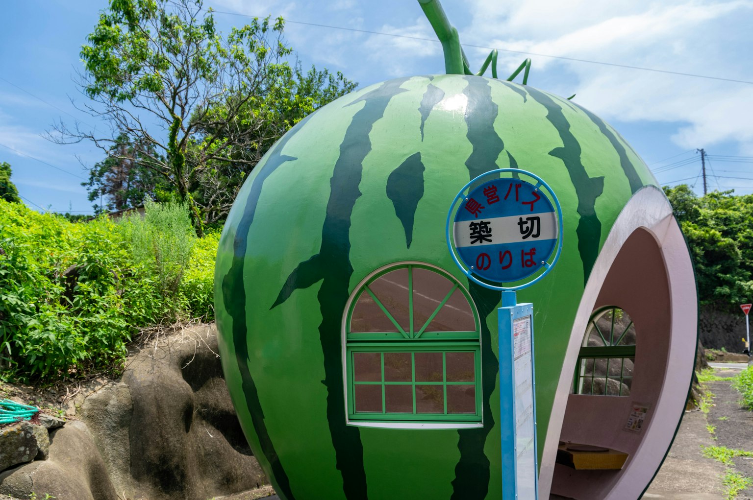 Unique watermelon-shaped structure with a blue sky