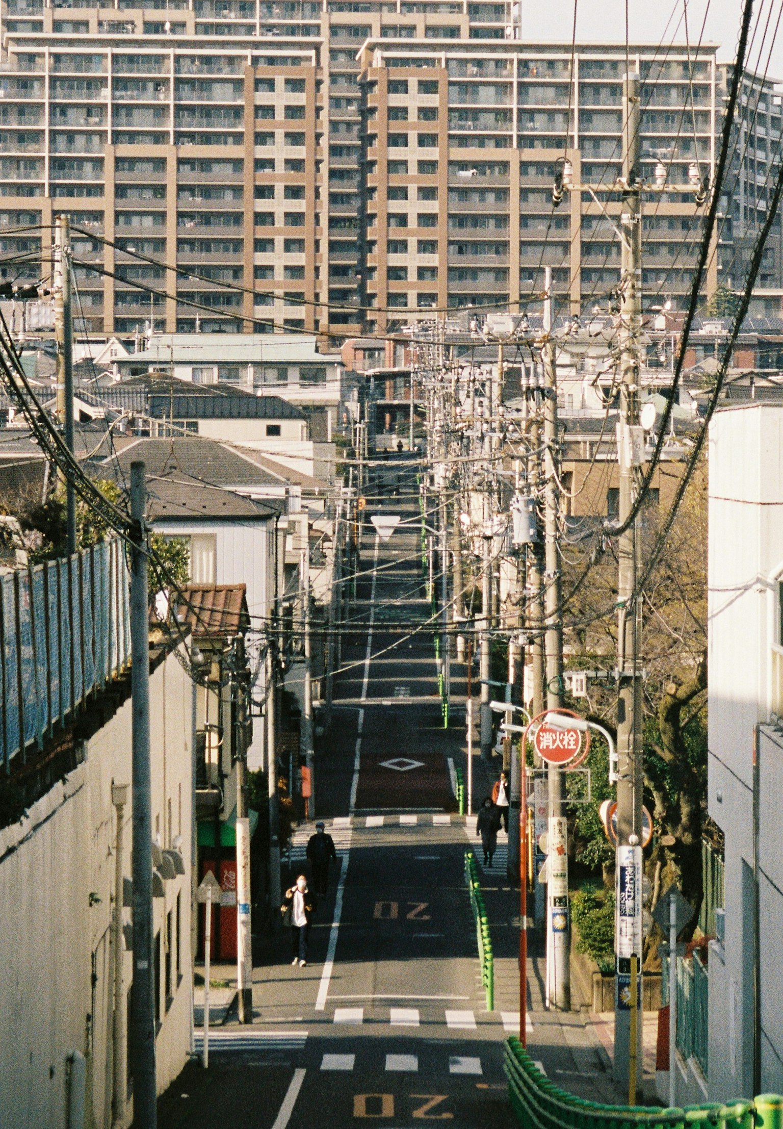 Urban landscape featuring narrow street and high-rise buildings