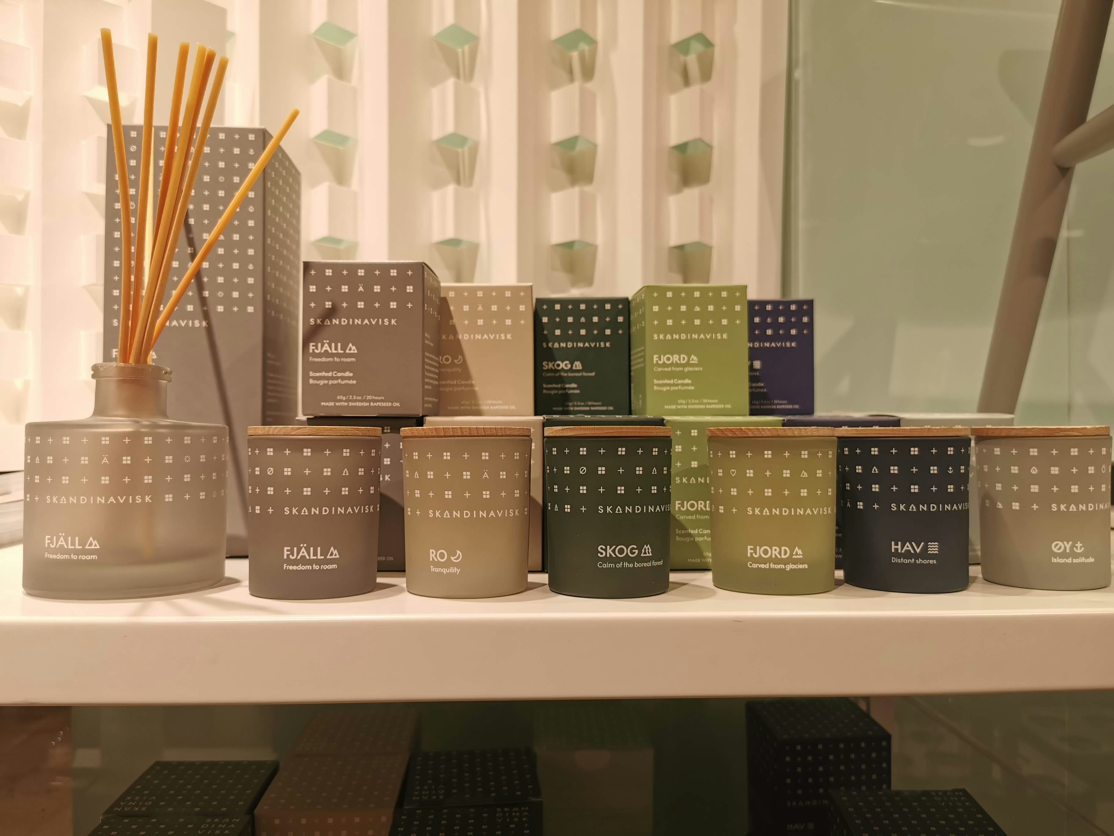 shelf display with reed diffusers and perfume bottles
