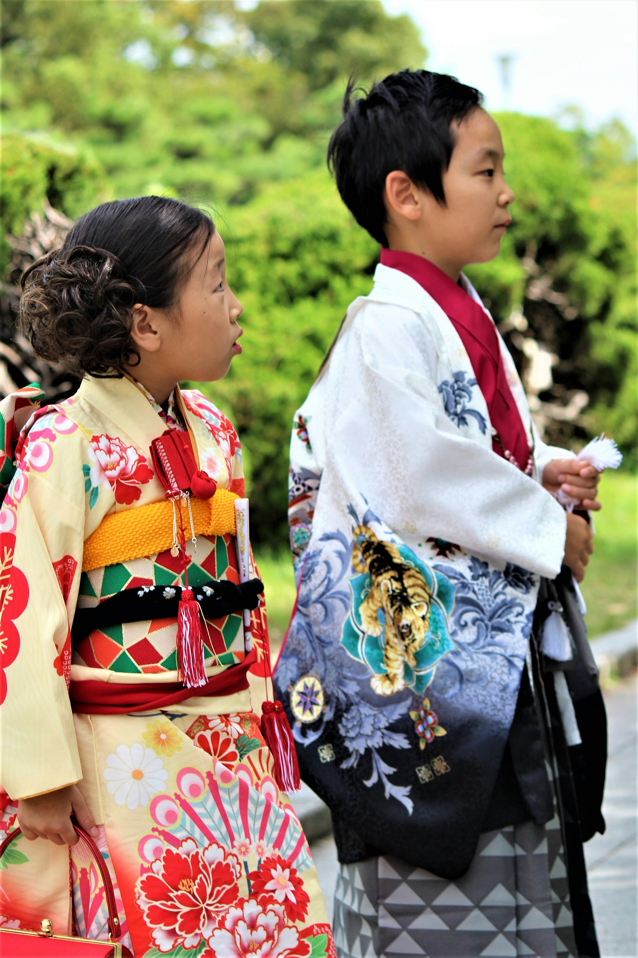 Children in colorful kimono standing outdoors