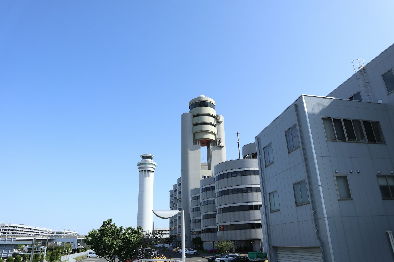 Modern buildings and a tower under a clear blue sky
