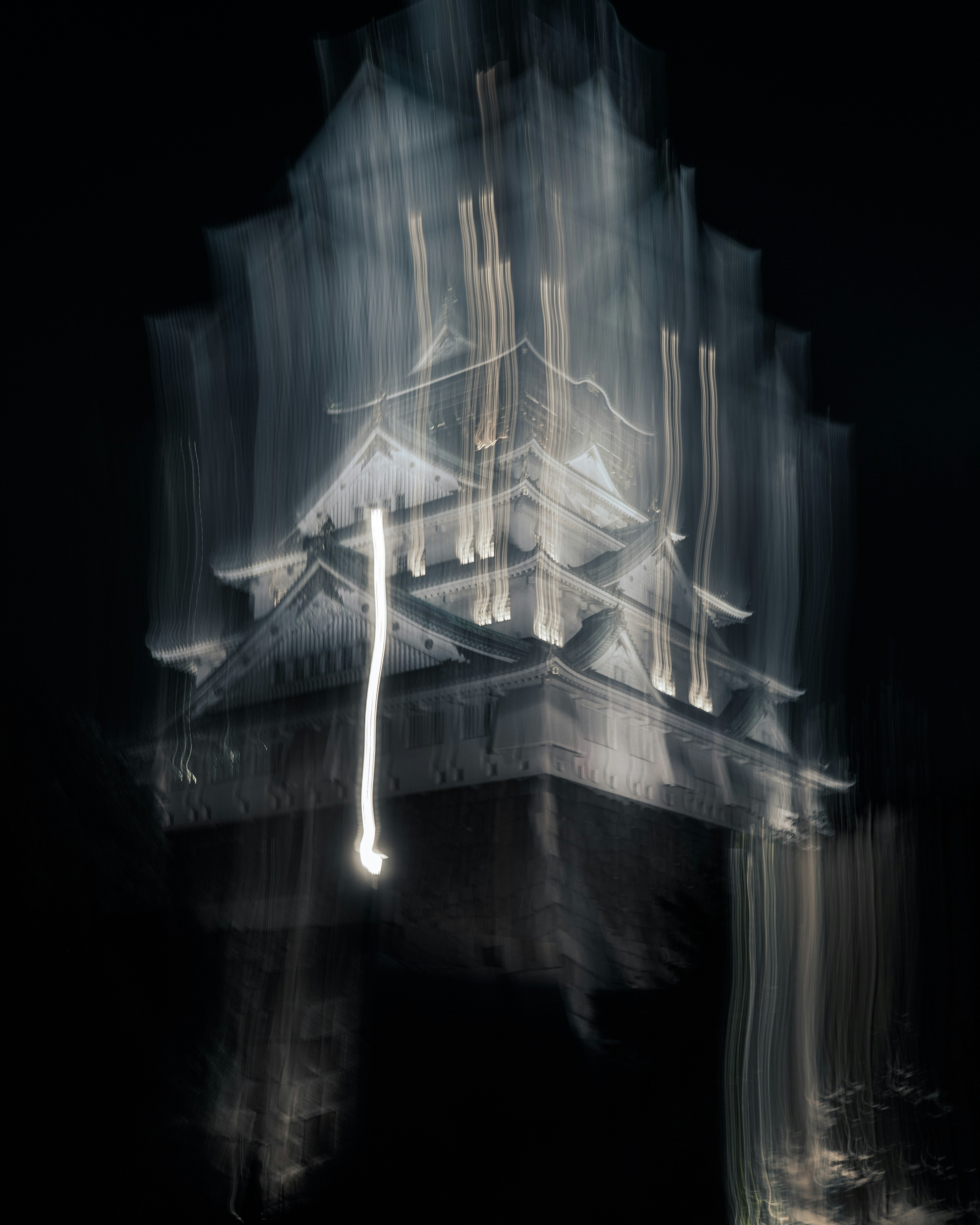 neon-like light trails forming a building silhouette at night