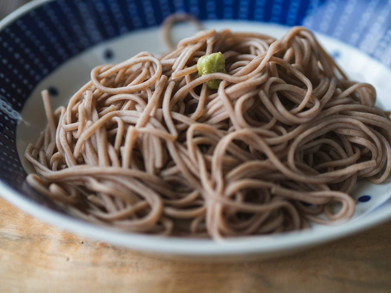Soba noodles served in a blue patterned bowl