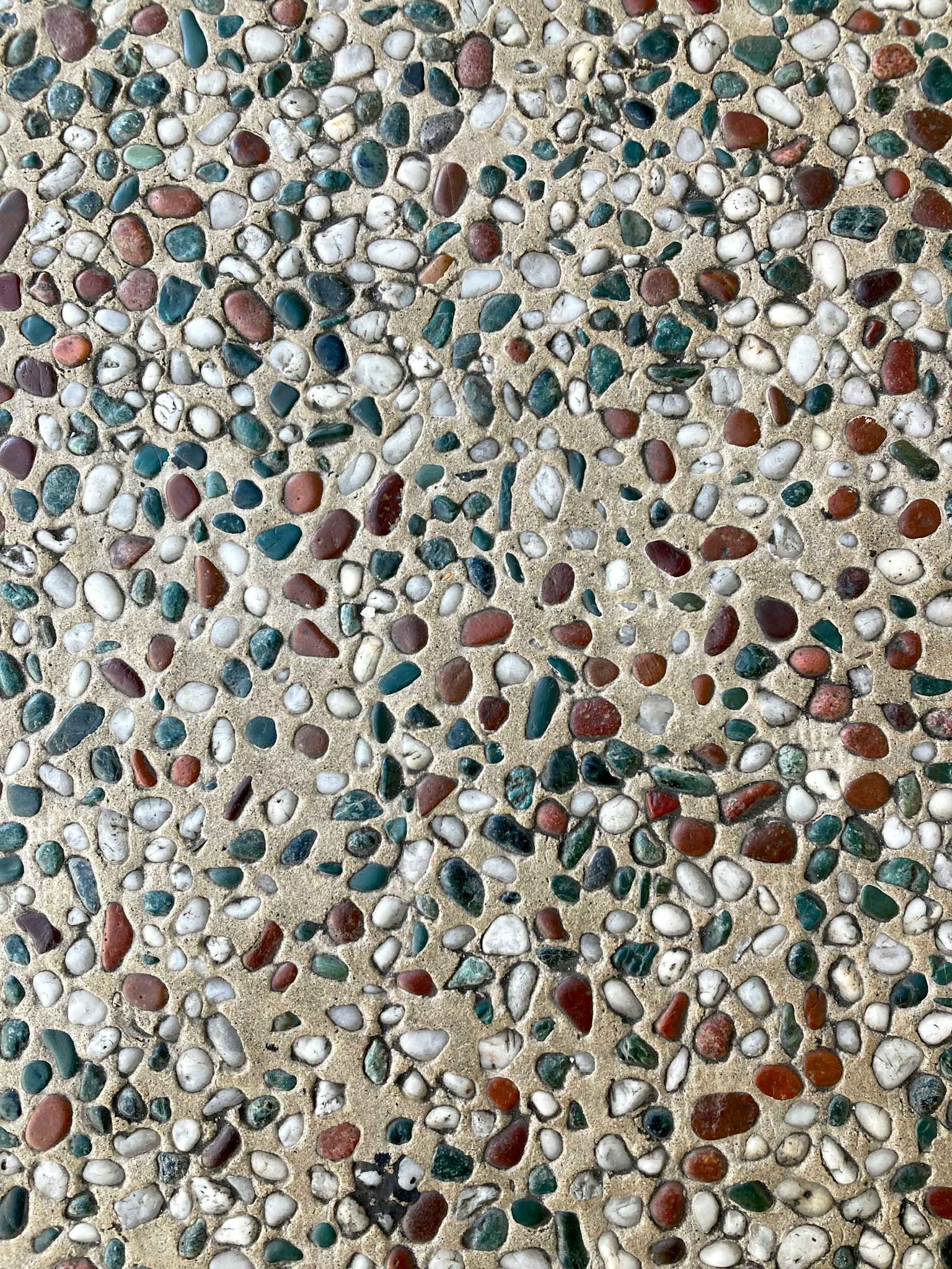 Texture d'une surface avec une variété de galets colorés intégrés