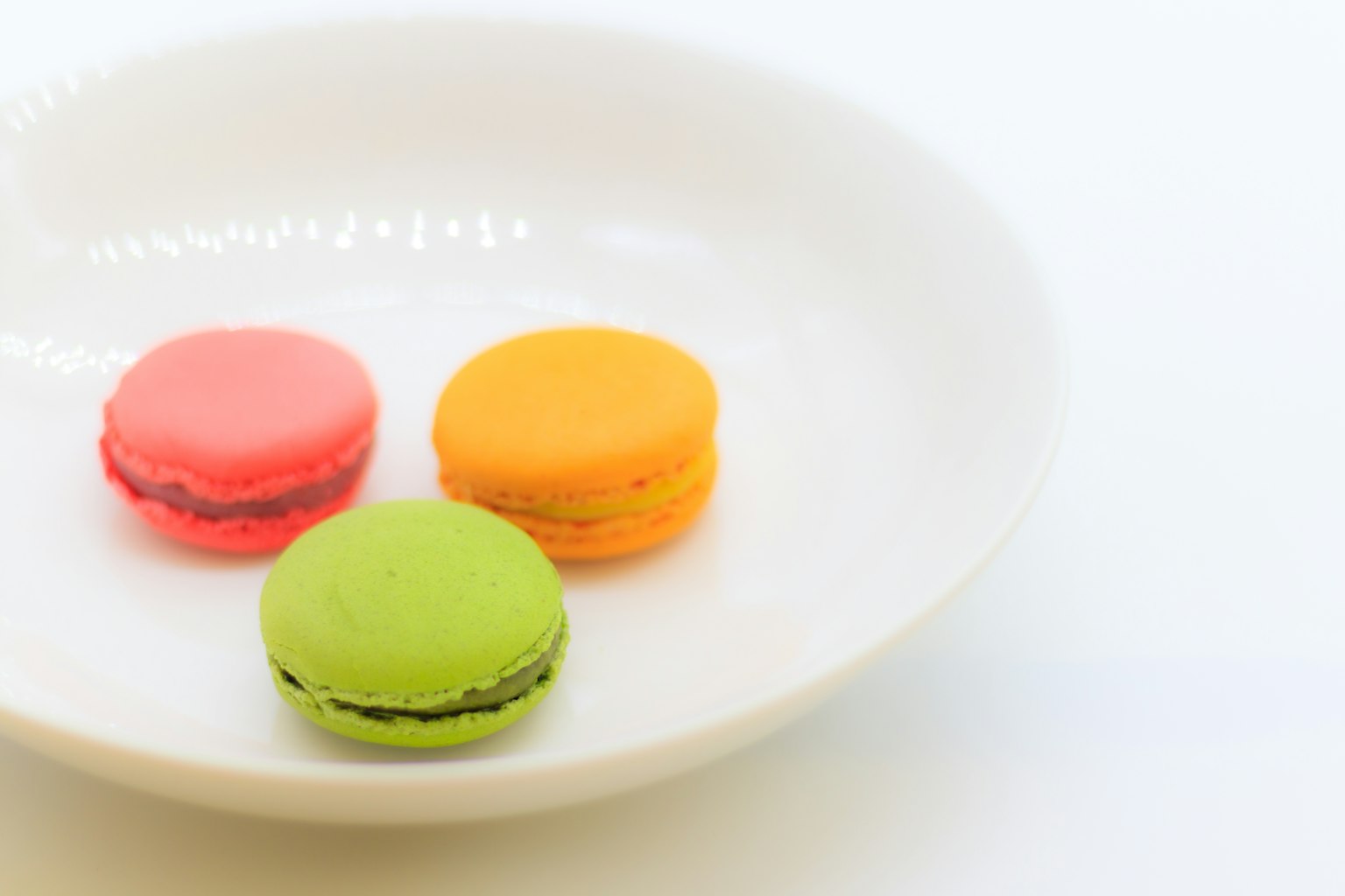 Colorful macarons on a white plate