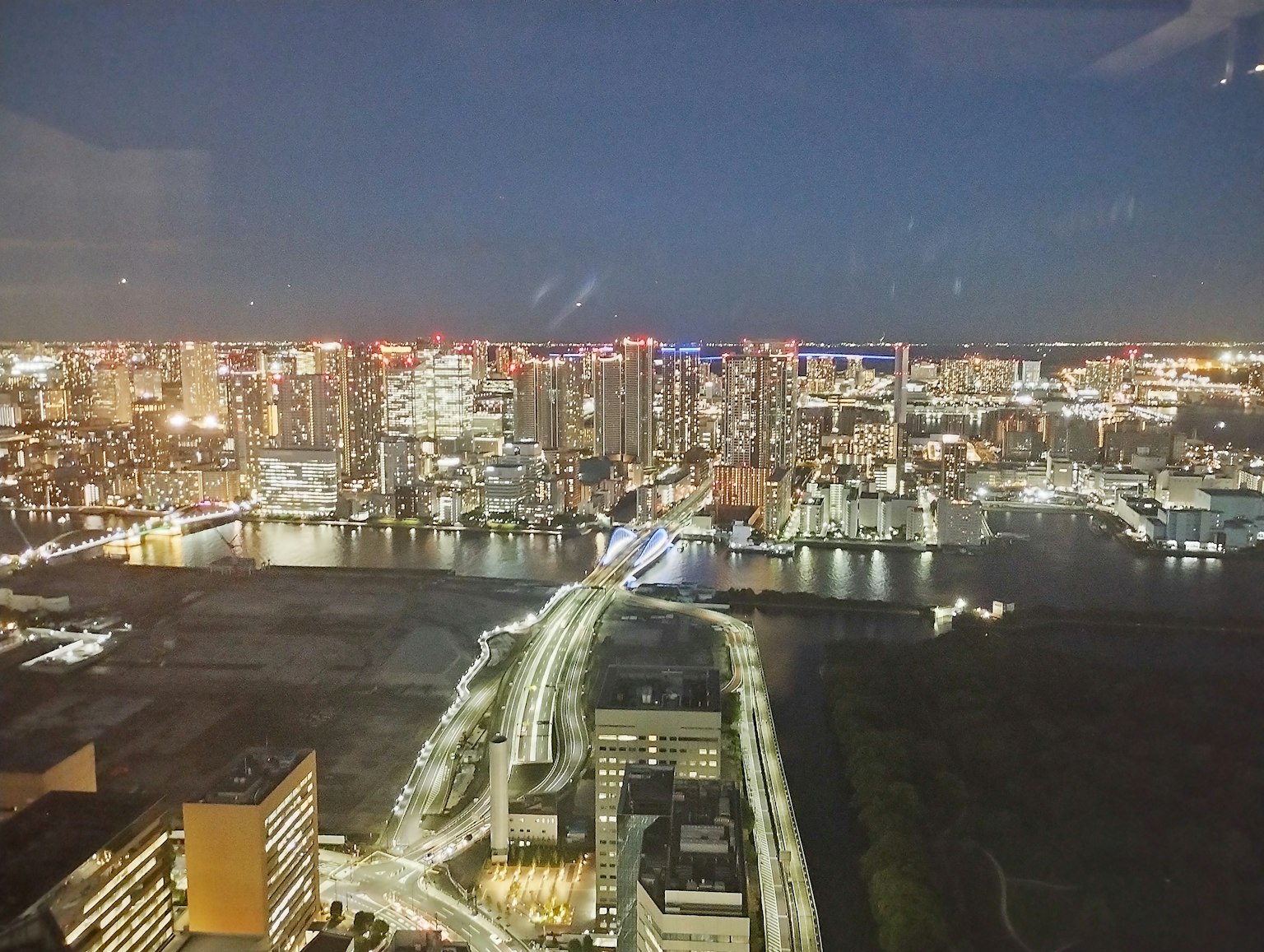Panoramic view of Tokyo Bay at night with illuminated skyscrapers