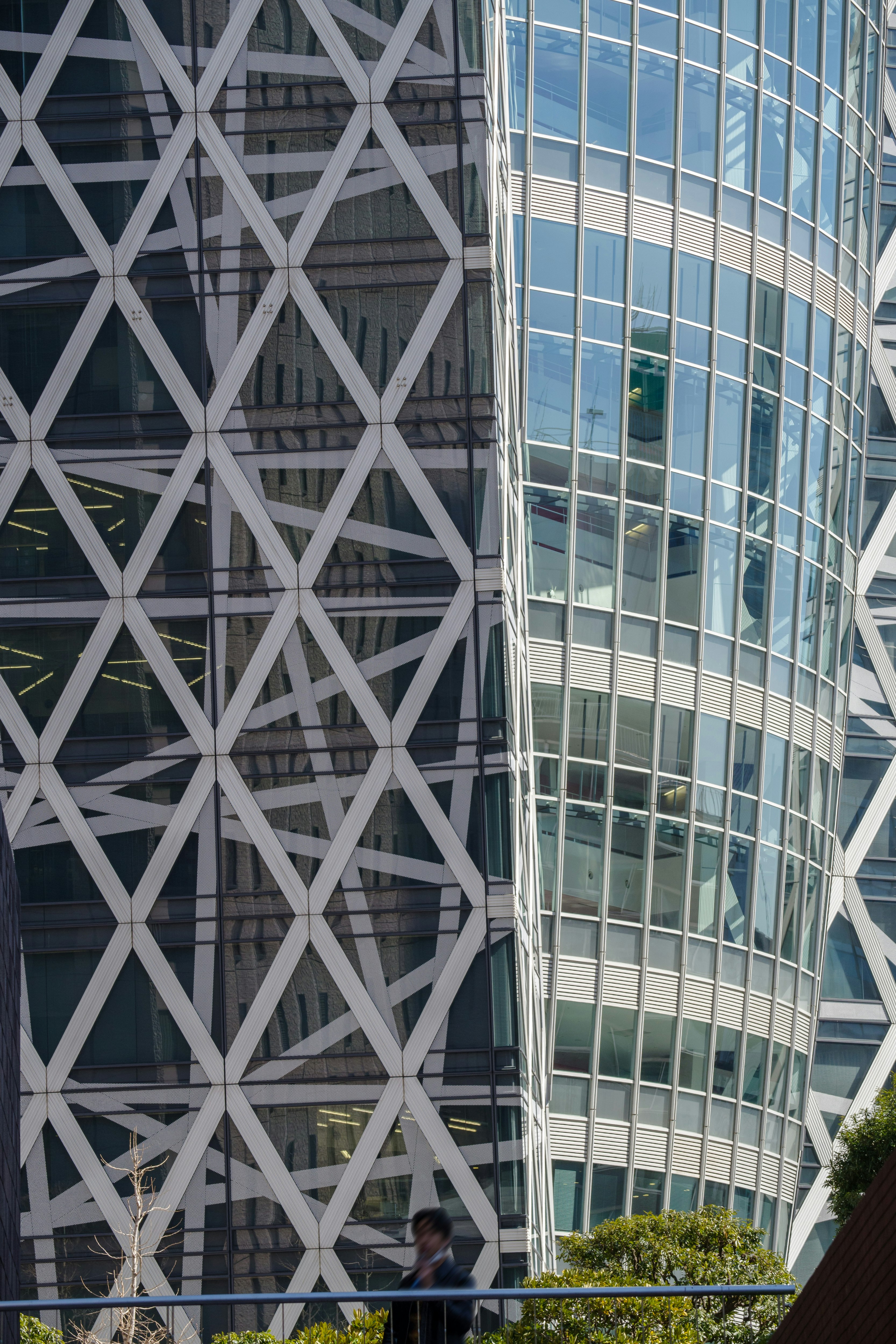 Modern building with complex facade featuring glass windows and geometric design