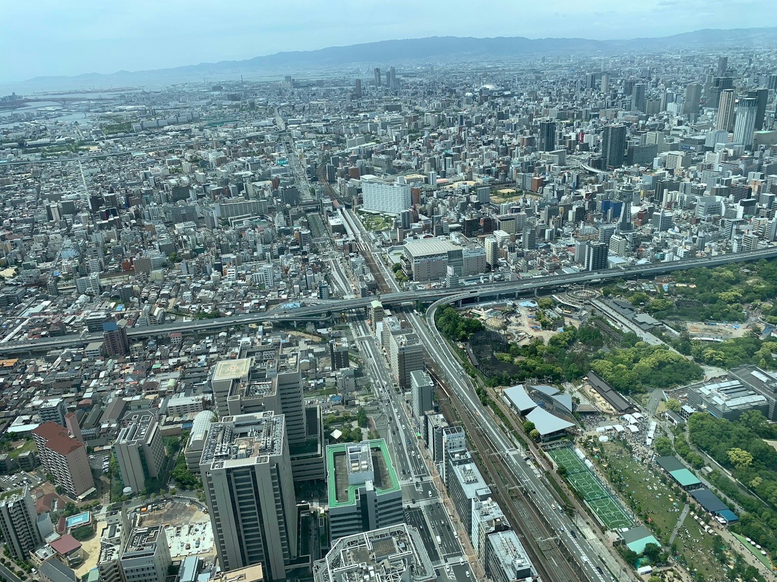 Aerial view of a sprawling urban landscape with skyscrapers and highways