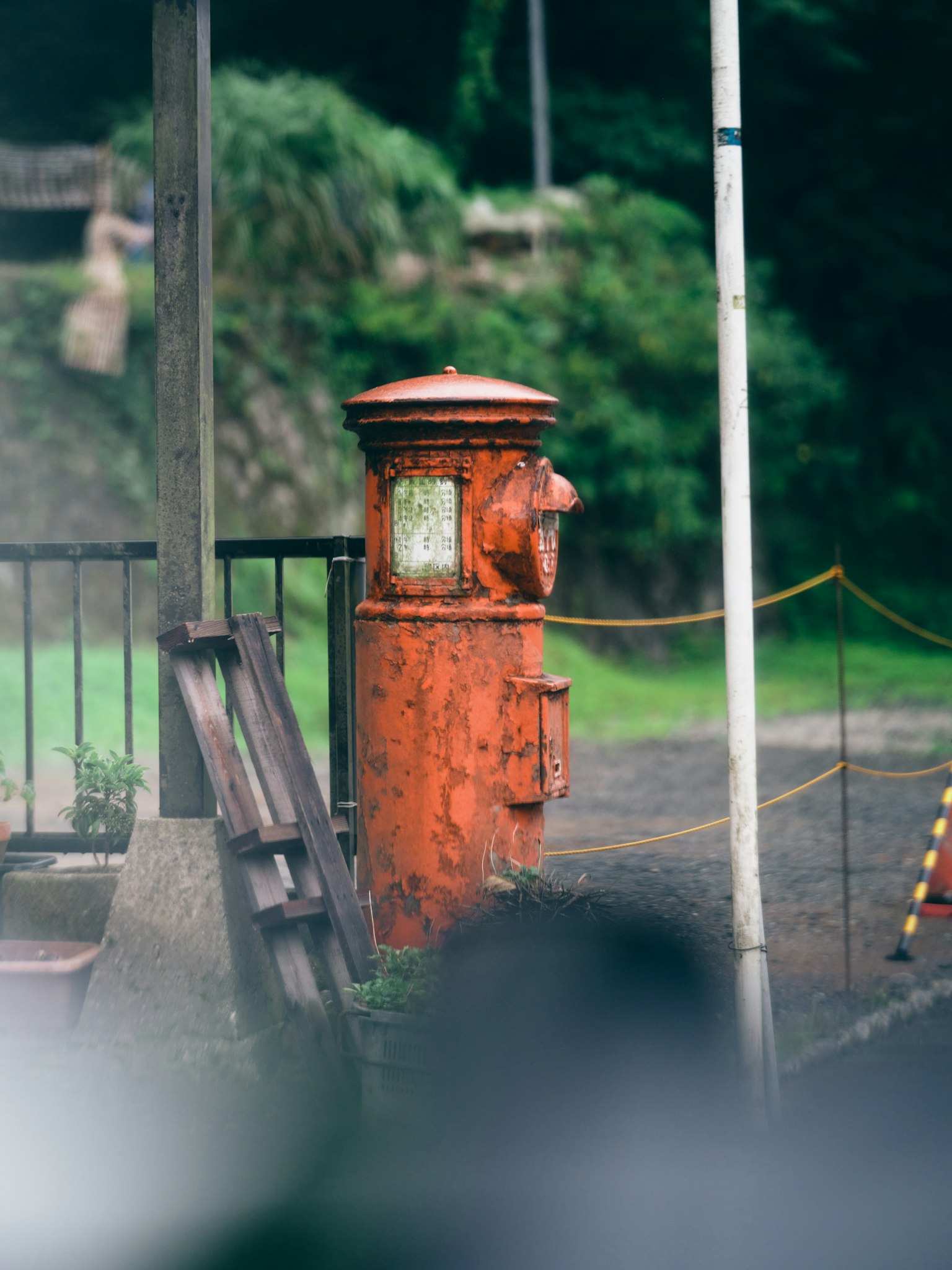 Red postal box standing against a green background