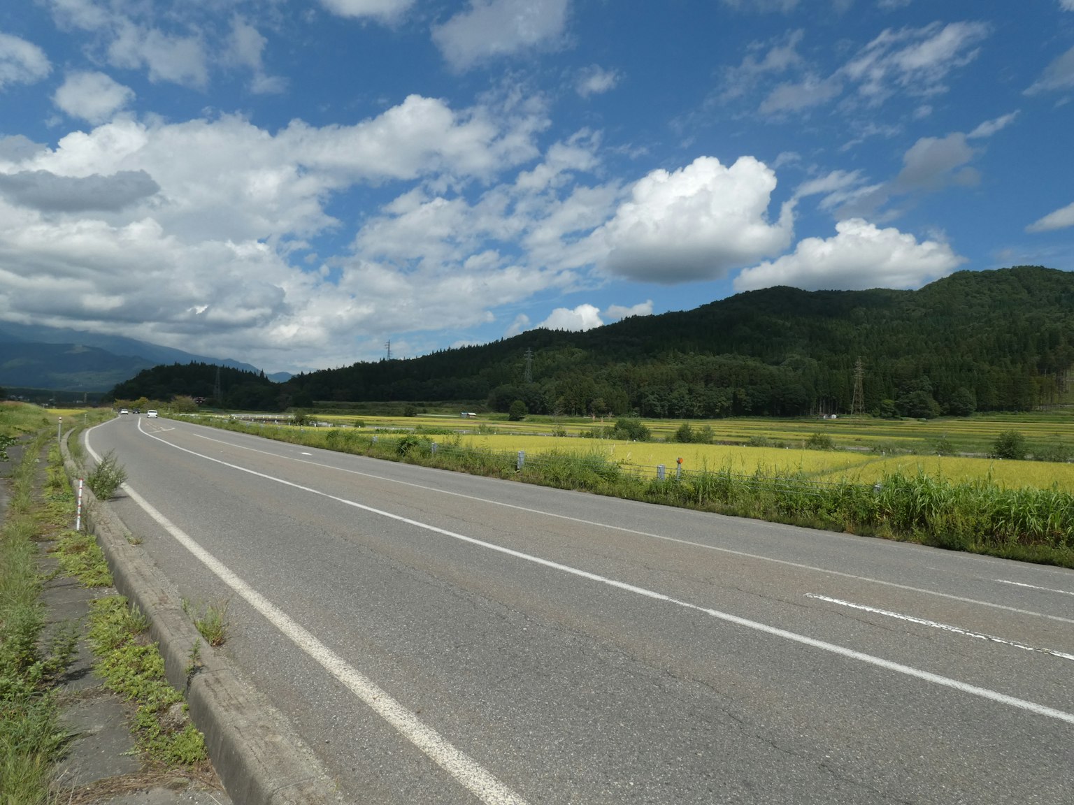 Countryside road with blue sky and white clouds