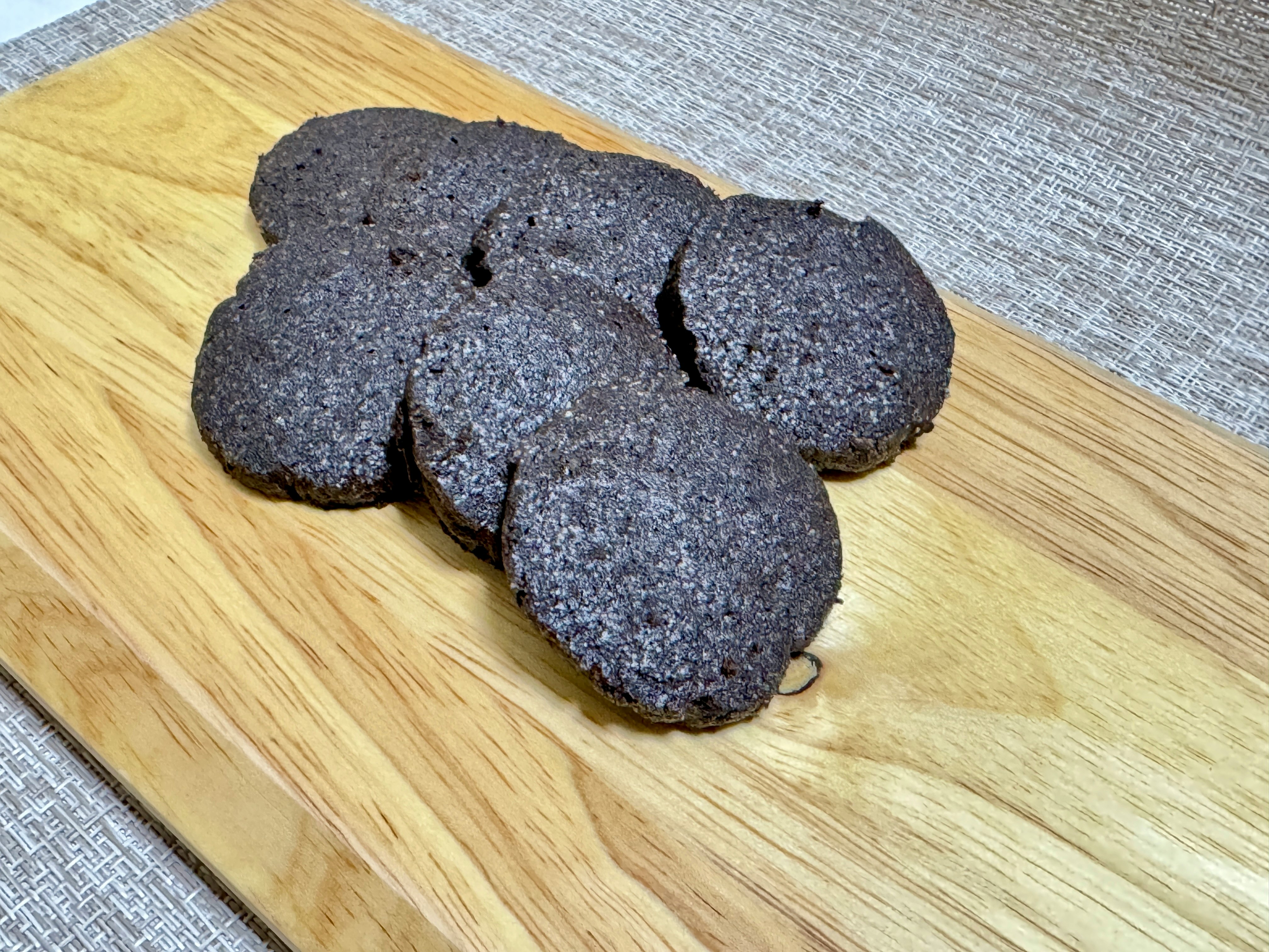 black sesame cookies on a wooden cutting board