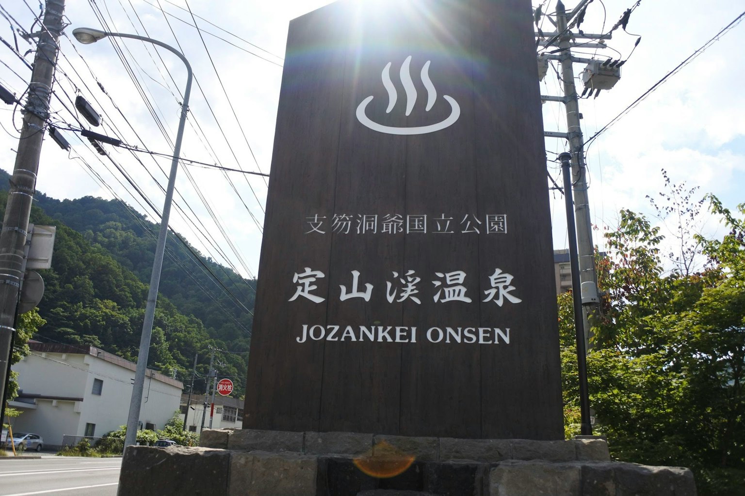 Cartel de Jozankei Onsen con fondo montañoso