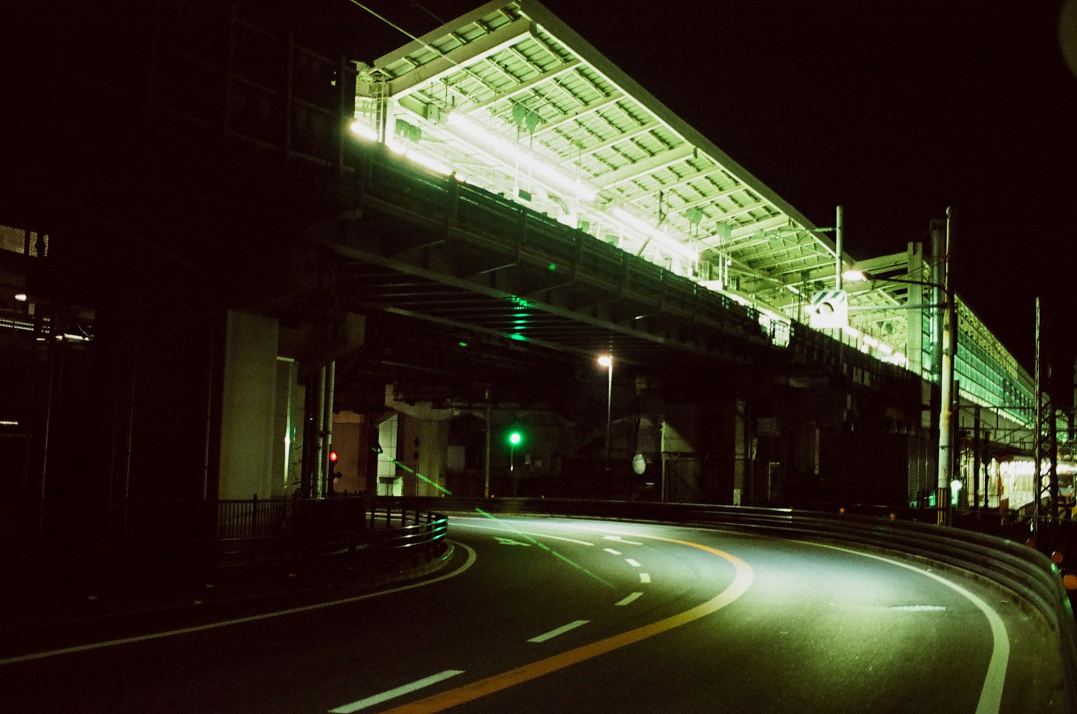 夜间的高架火车站与弯曲的道路