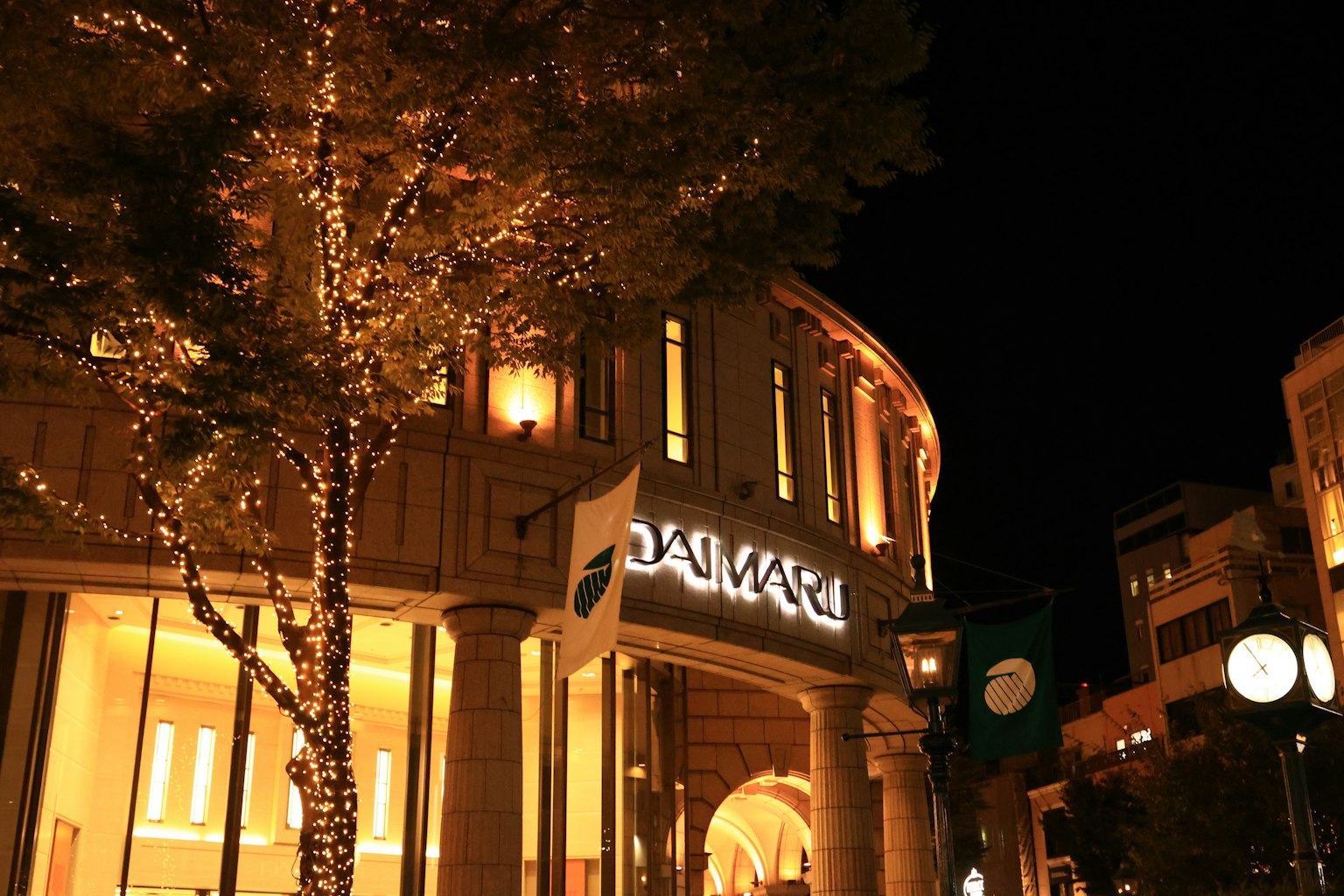 Illuminated storefront at night with decorative lights