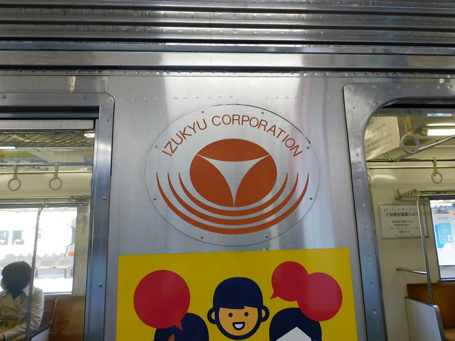 Interno di un treno con il logo della Izukyu Corporation