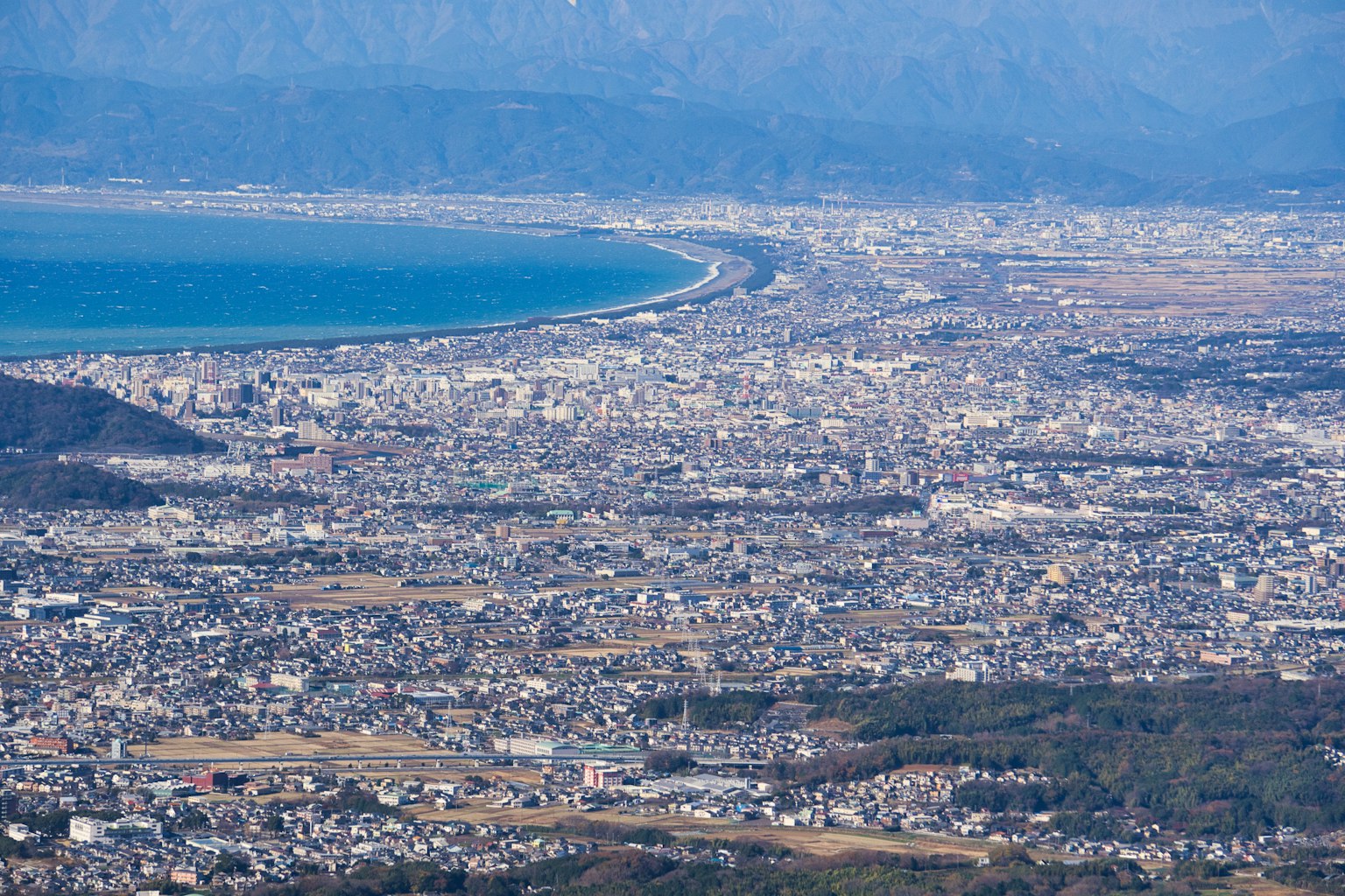 Aerial view of a coastline and sprawling city landscape