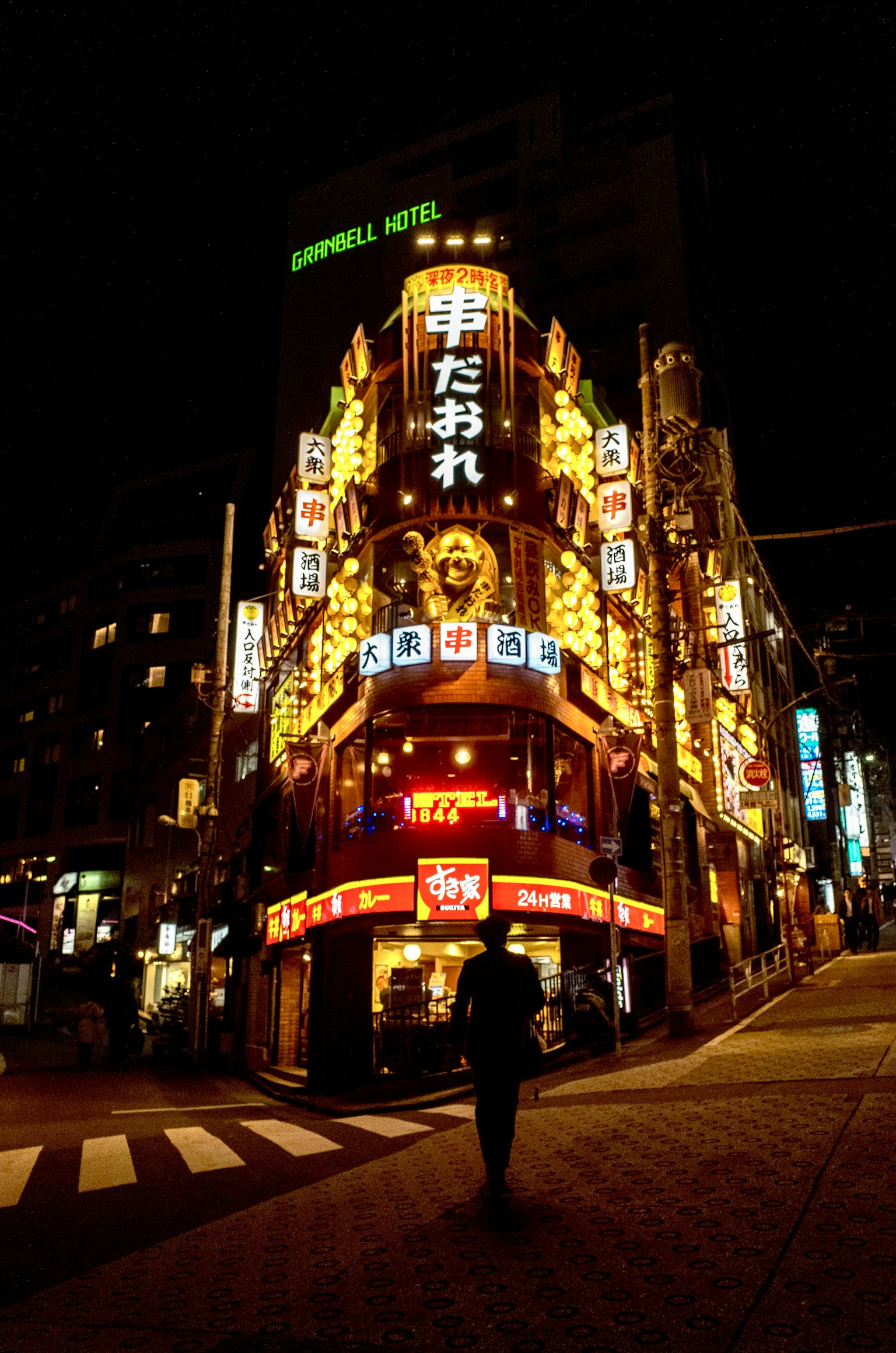 Exterior of a vibrant restaurant with neon signs at night