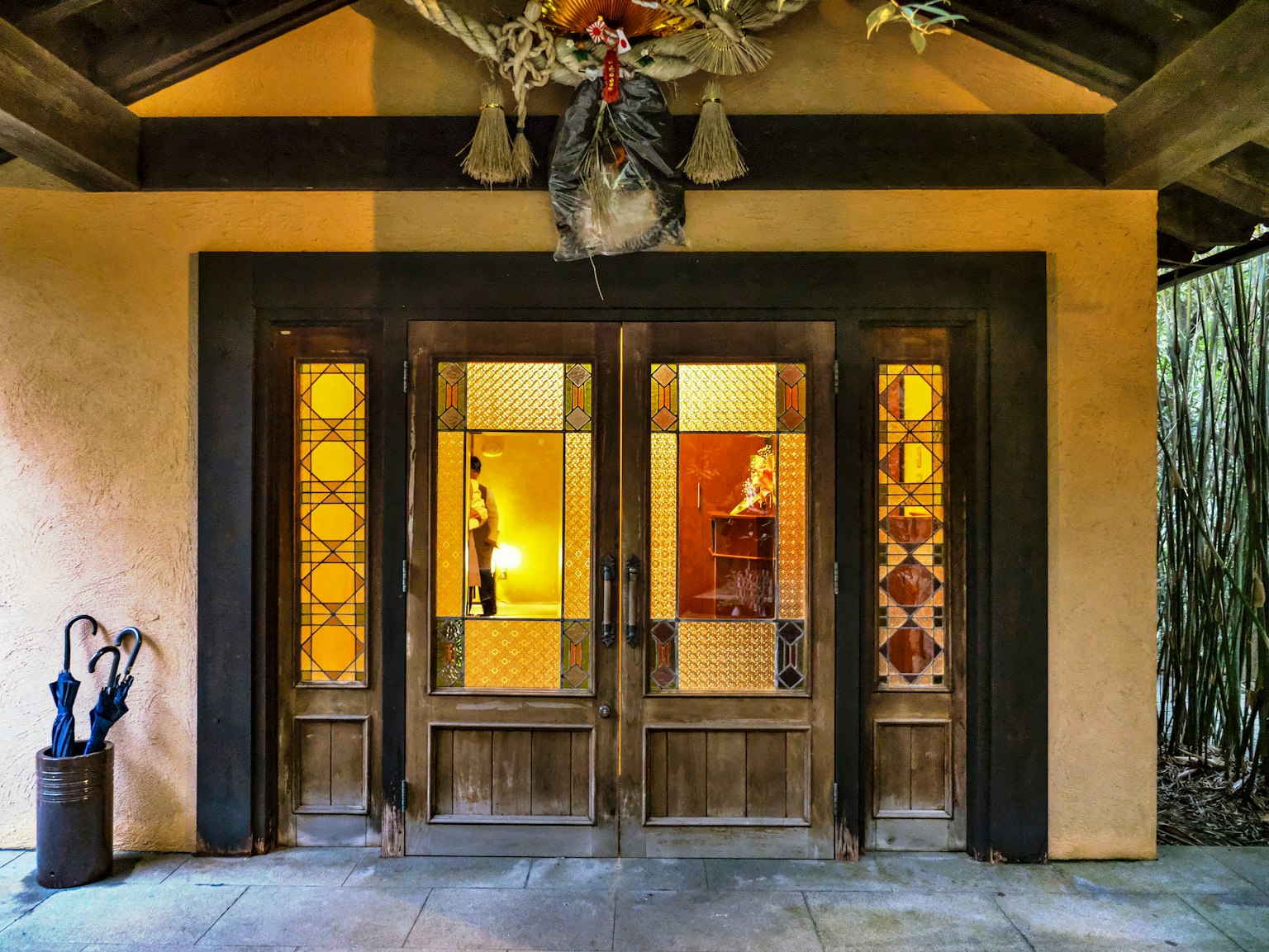 Entrance with wooden doors and decorative wall features