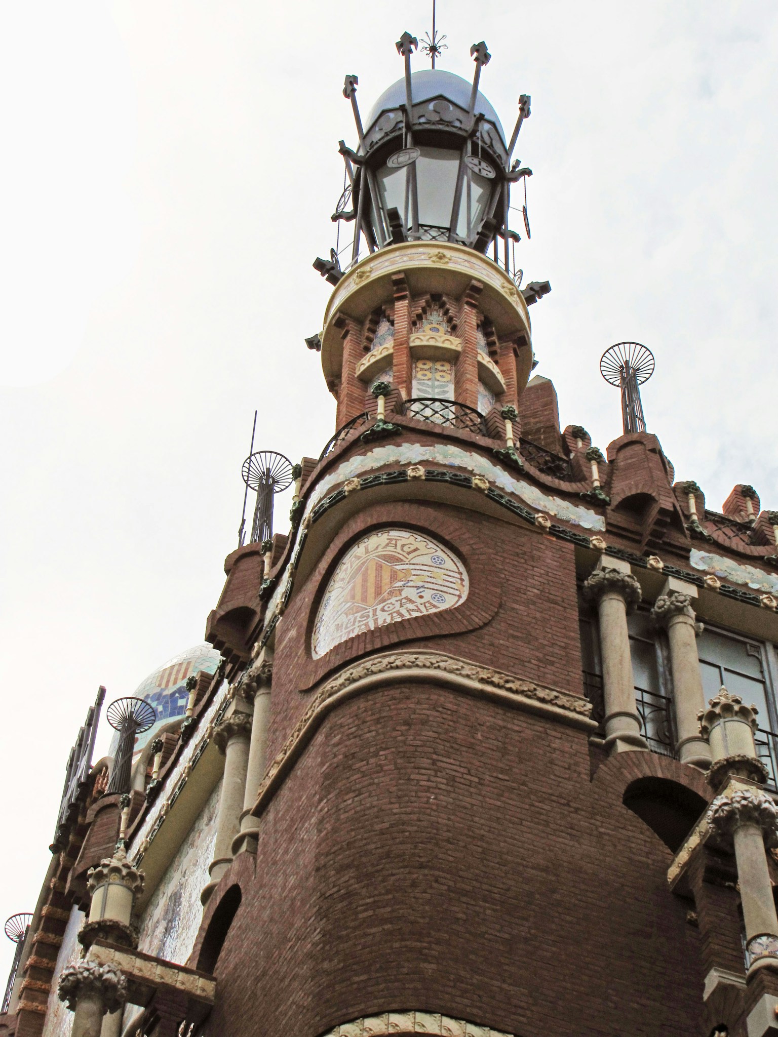 Part of a building featuring a unique tower and decorative brick exterior