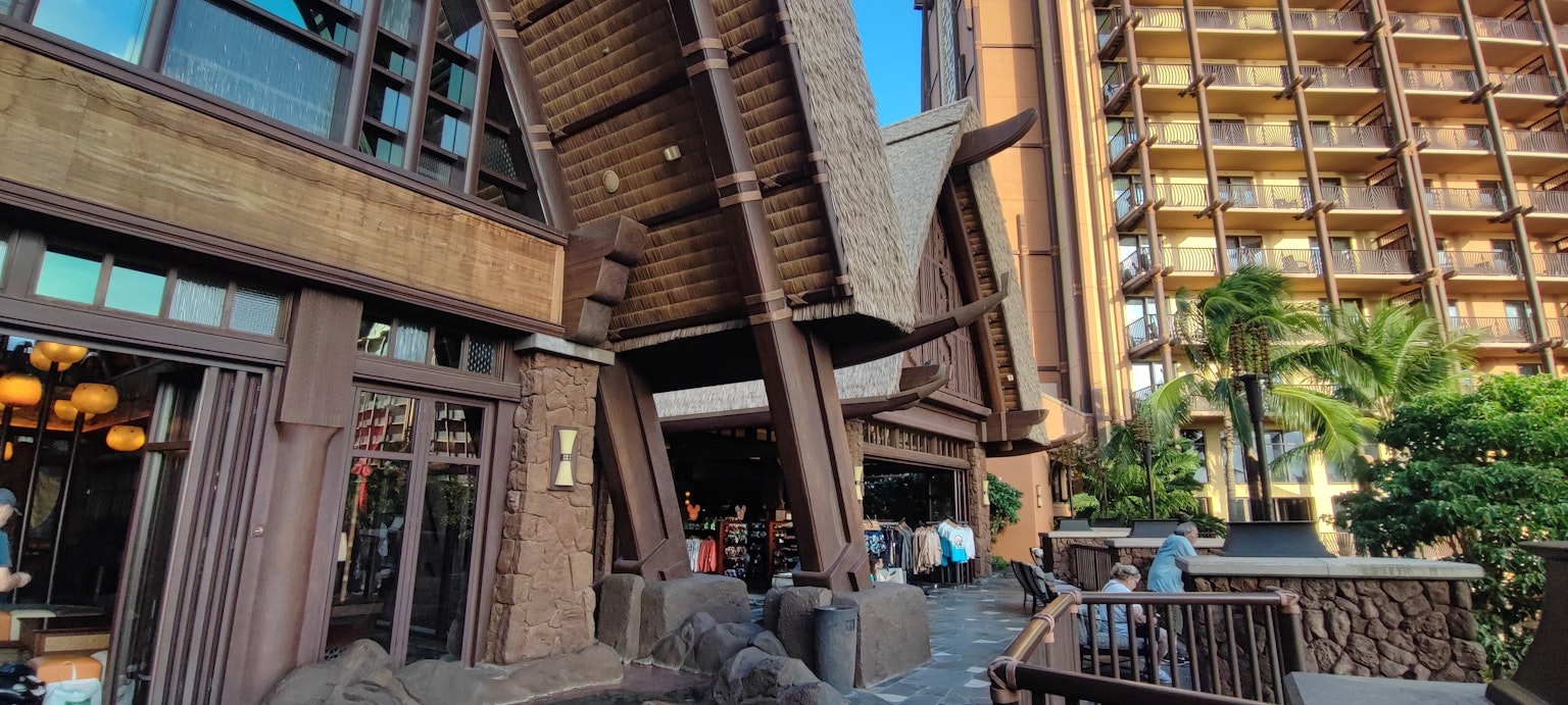 Entrée d'un grand bâtiment en bois avec une végétation environnante