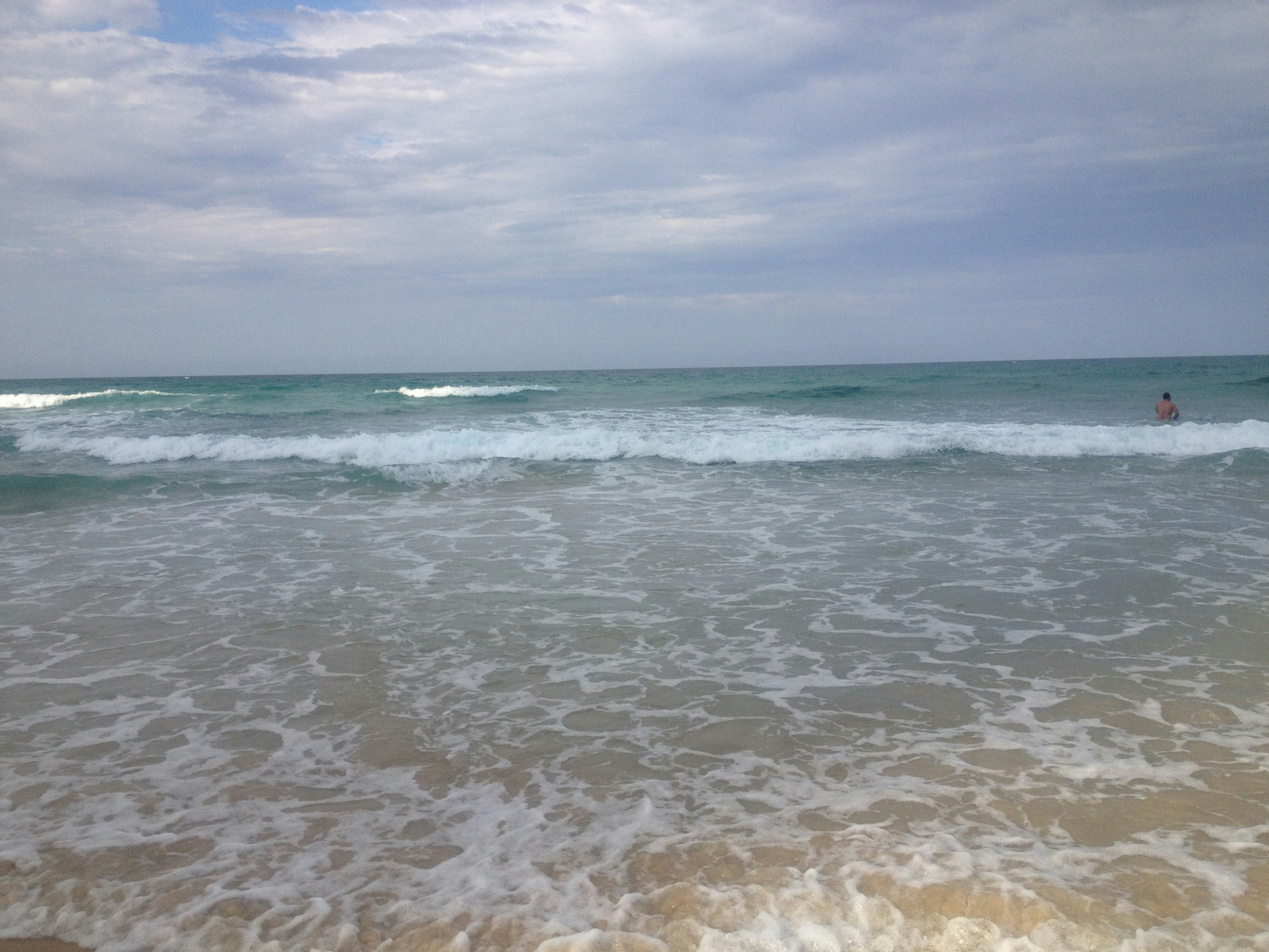 onde calme sulla riva e cielo aperto