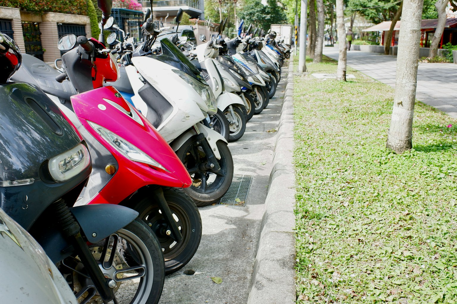 แถวของสกูตเตอร์ที่จอดอยู่ตามถนน